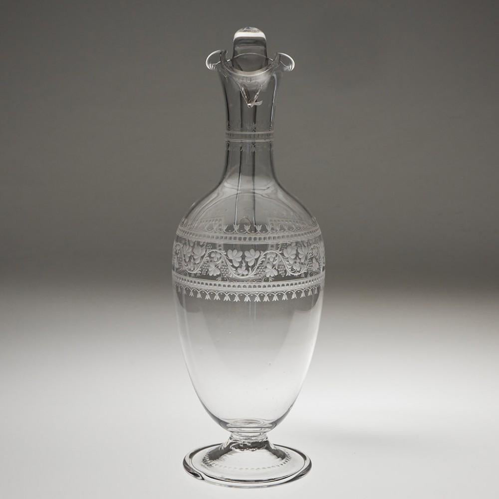 Heading : A Fine Victorian Engraved Claret Jug c1870
Date : c1870
Period : Victoria
Origin : England
Colour : Clear
Body : Amphora shape. Engraved with a mirror pair of bands with polished printies and arches with a fruiting vine theme within, the