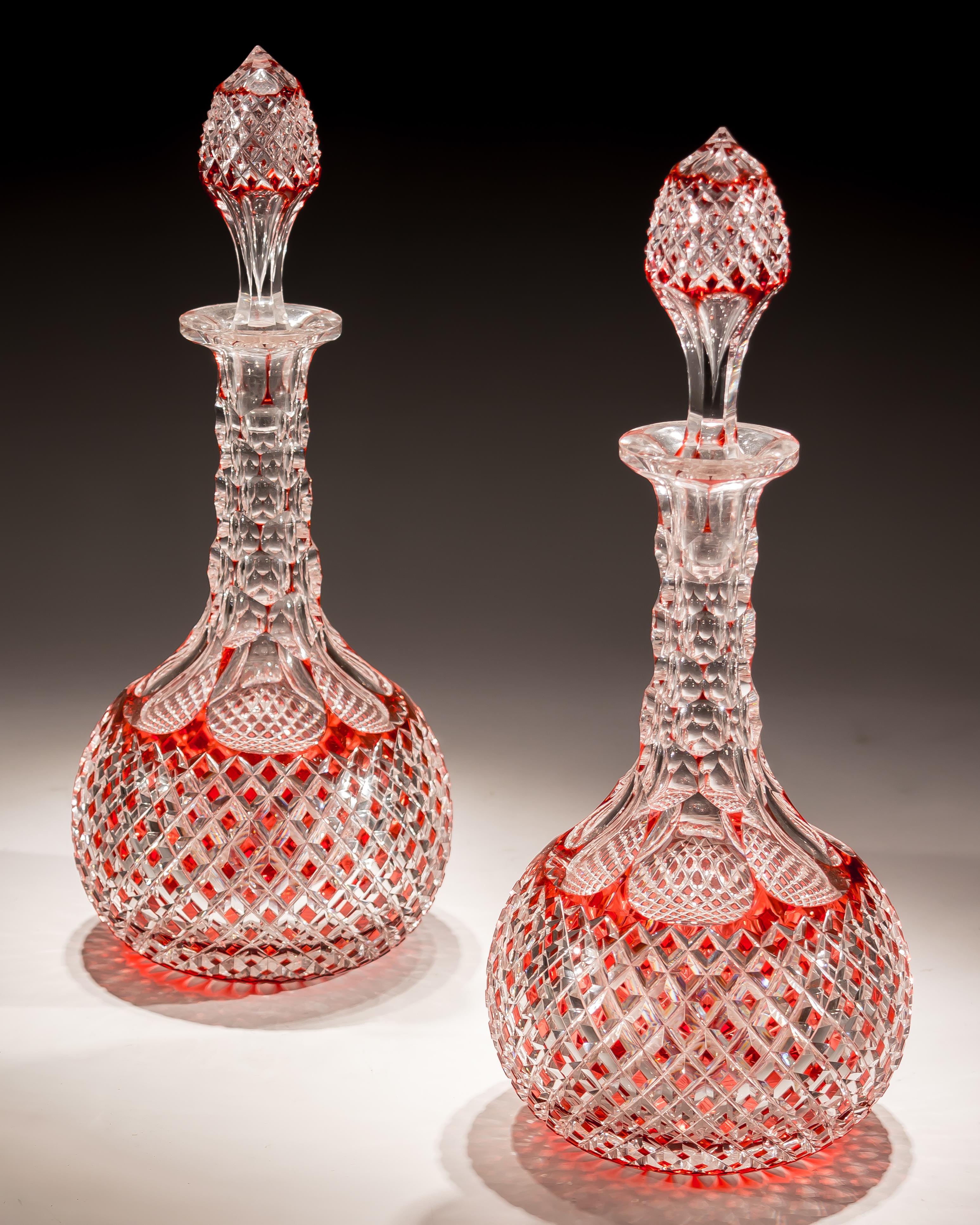 A fine Victorian red overlay suite consisting of a pair of elaborately cut glass decanters and seven matching wine glasses.

Wine glasses
H 12cm / 4.75