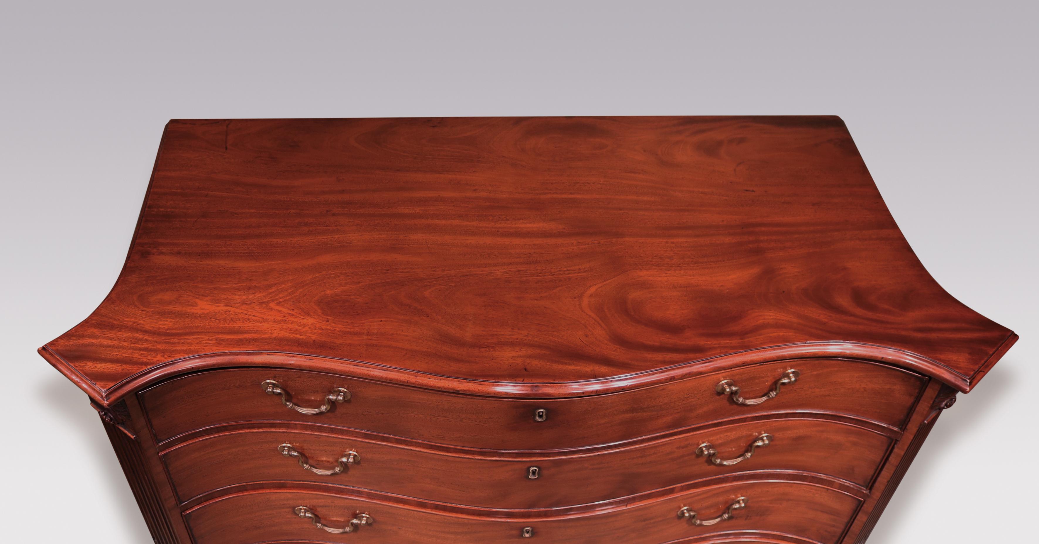 An impressive mid-18th century Chippendale period figured mahogany serpentine commode, having well-shaped moulded edged top above 4 cockbeaded graduated drawers flanked by canted corners with boldly carved acanthus leaves above fluted columns with