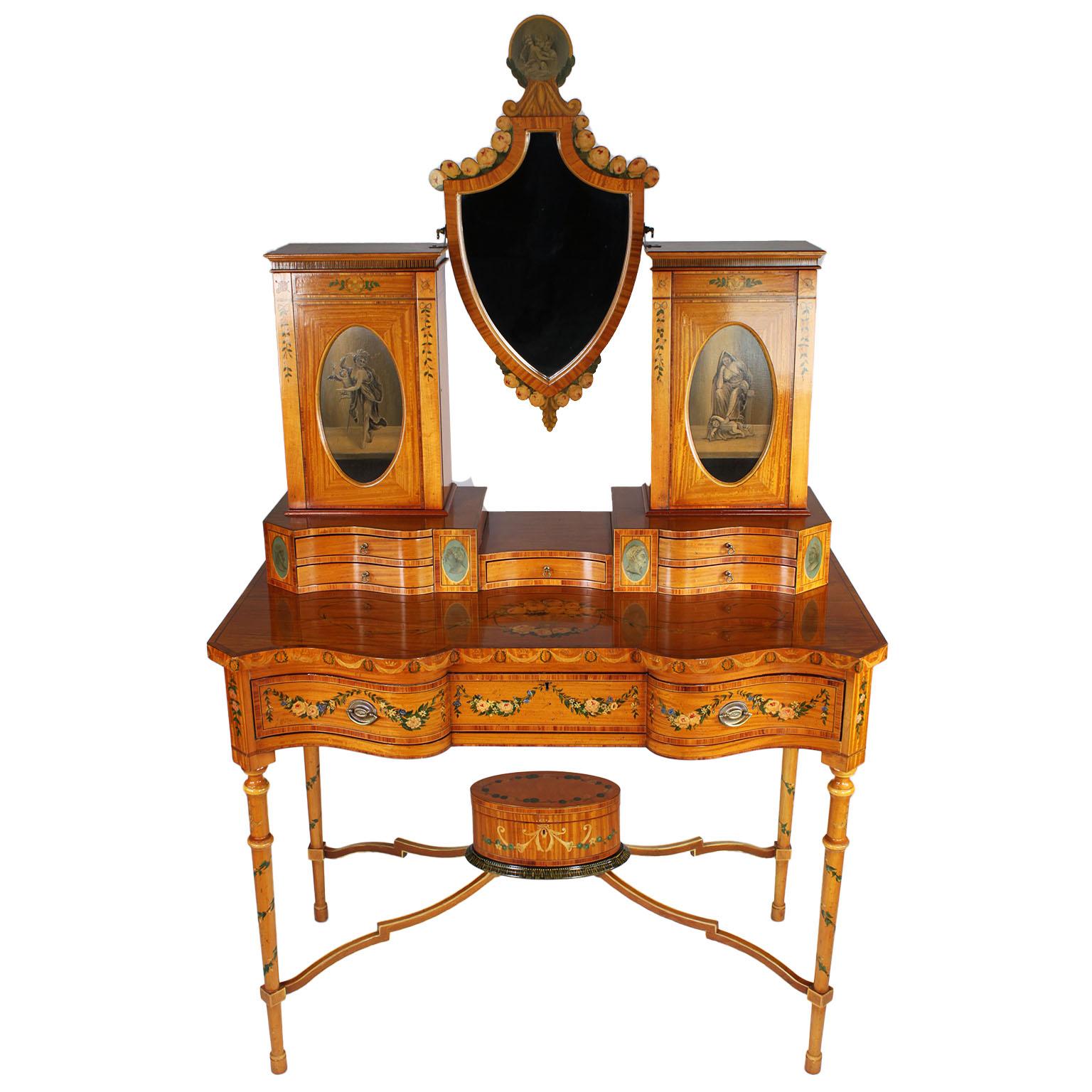 A very fine English 19th century Adam style Polychrome painted satinwood vanity table. The ornately decorated cabinet surmounted with an easel mirror flanked by a pair of storage compartments centered with oval paintings, all above five top drawers,
