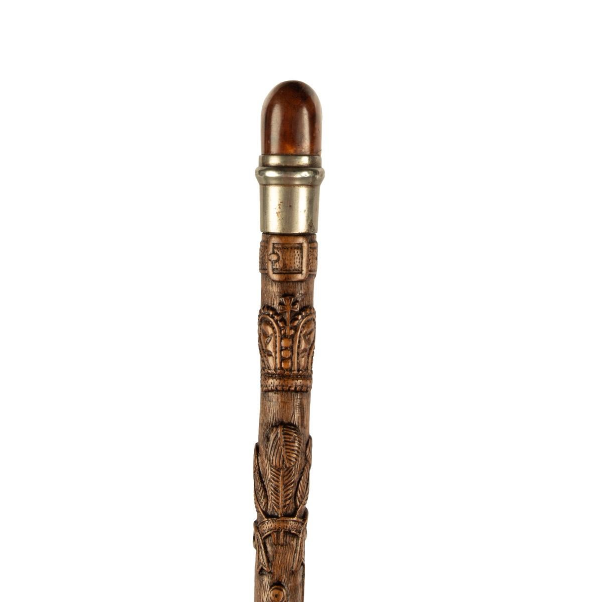 A finely carved fruitwood cane with royal and masonic symbols 1