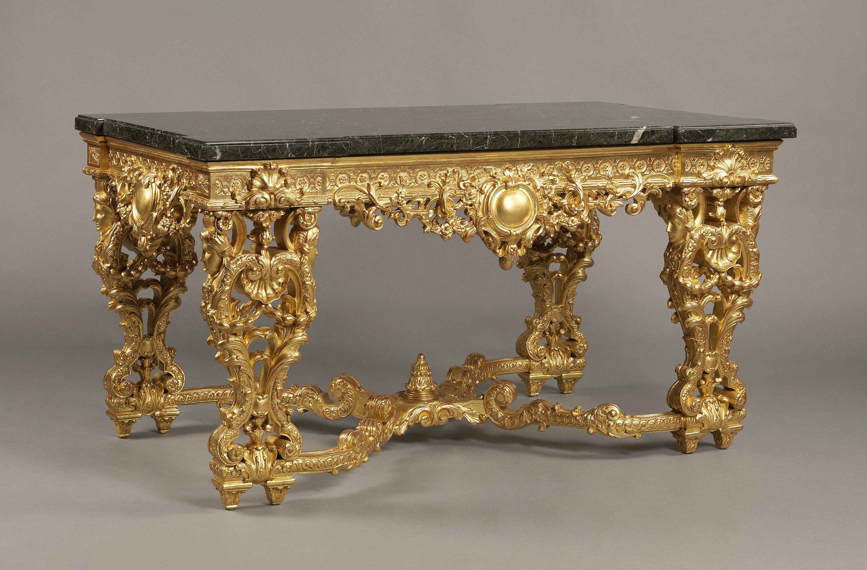 A finely carved Louis XIV/Regence style giltwood centre table with a rare Patricia green Italian marble top.

French, circa 1880. 

This impressive centre table is based on the celebrated table made for the Château de Bercy now in the Louvre,