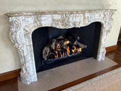 A Finely Carved Louis XV Style Fireplace Mantel in Figured Italian Marble