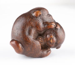 A Finely Carved Wood Netsuke of Two Puppy Dogs Playing
