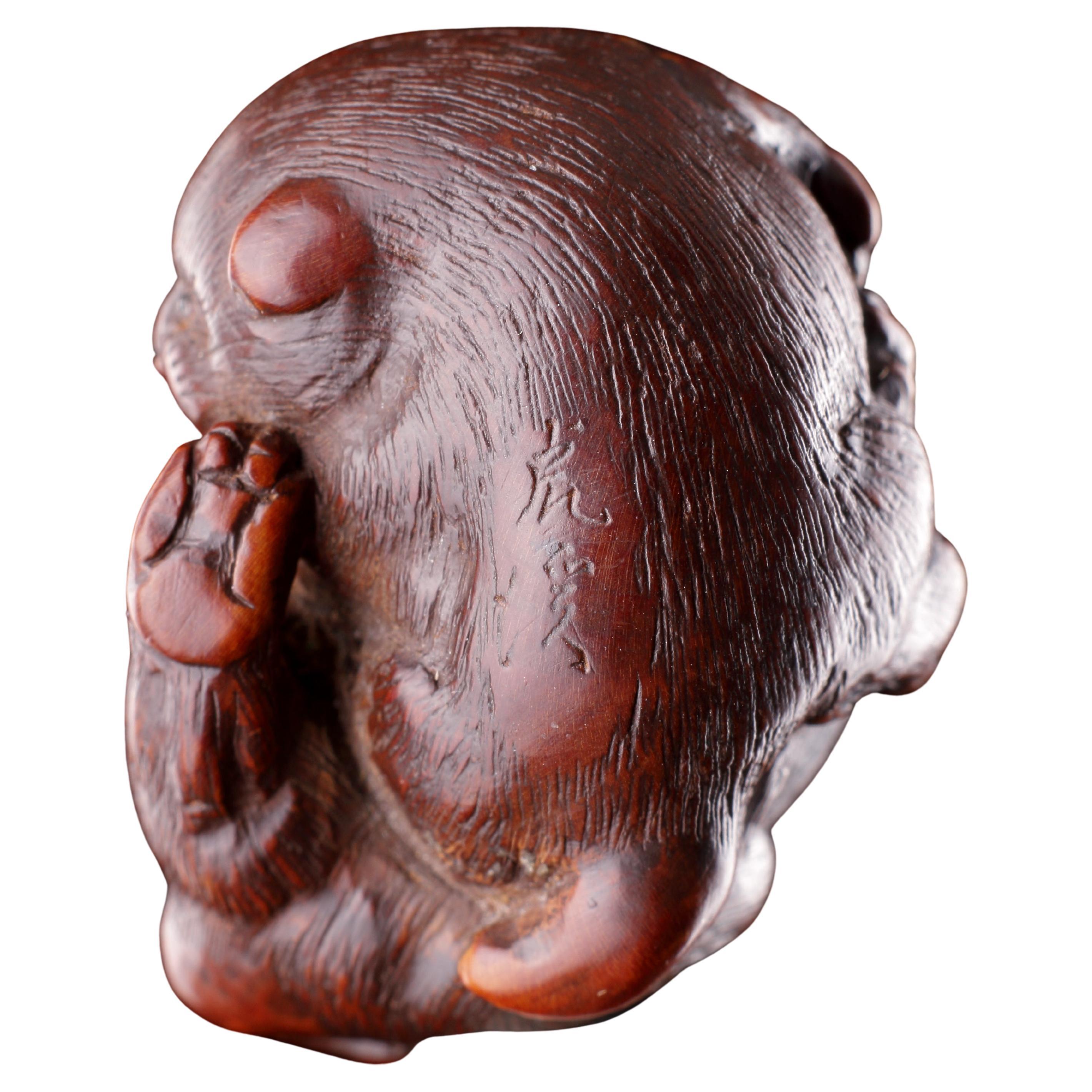 A Finely Carved Wood Netsuke of Two Puppy Dogs Playing