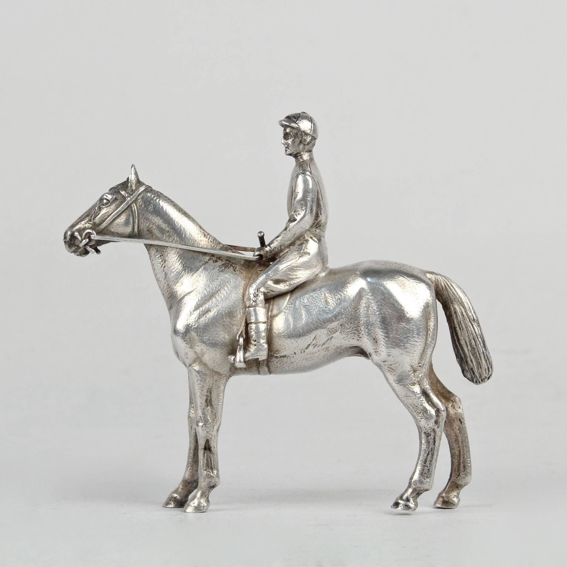 A very finely cast silver horse and jockey sculpture. 

The horse and jockey are depicted at rest.

The sculpture is unmarked. We believe that the silver fineness is coin or sterling.

Simply a stunning miniature objet d'art!

Length: ca. 3