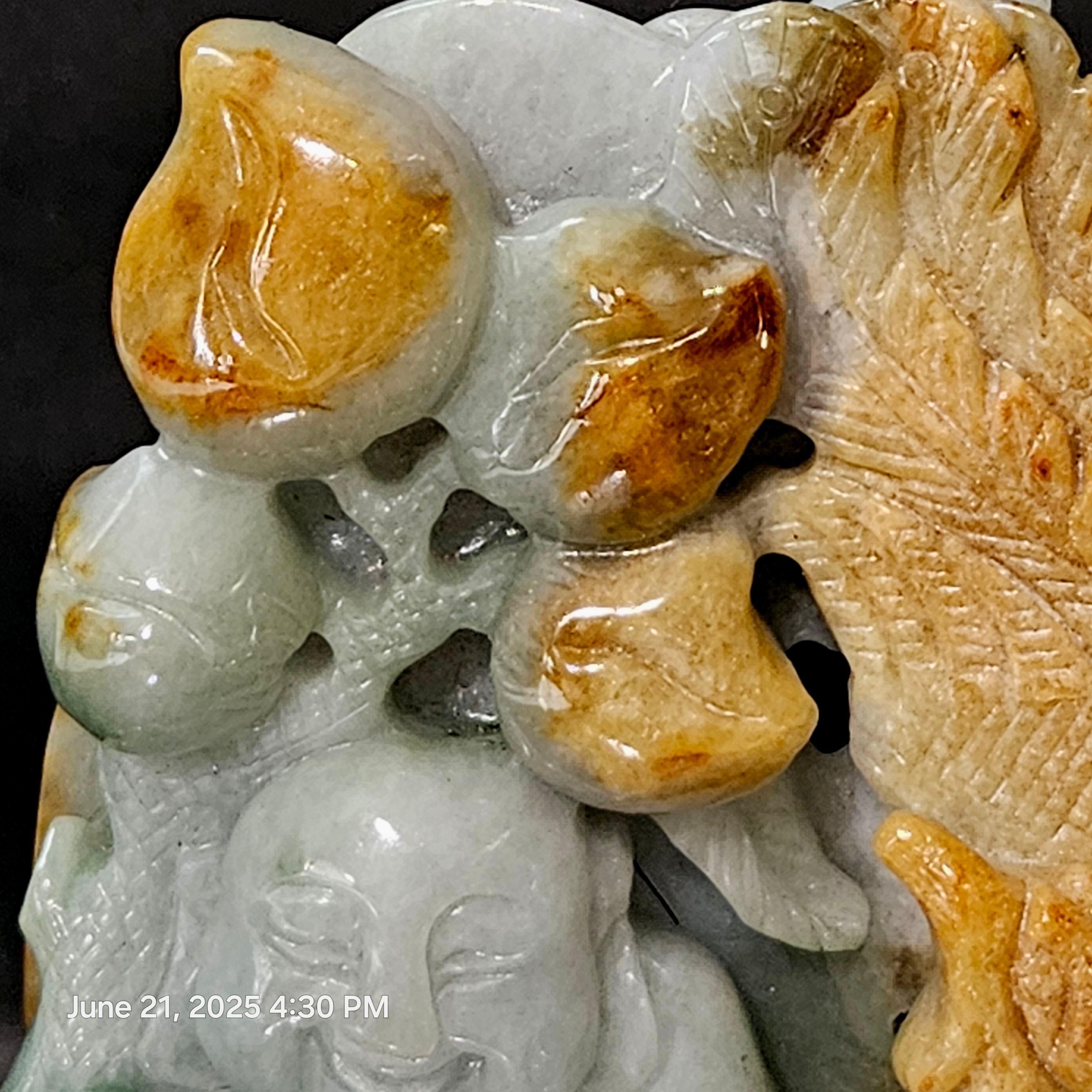 This is a lovely hand-carved jadeite depicting a Buddha seated on a wave and a fish aside in a cave under a peach tree, a very deliberate work with highly skilled craftsmanship.

