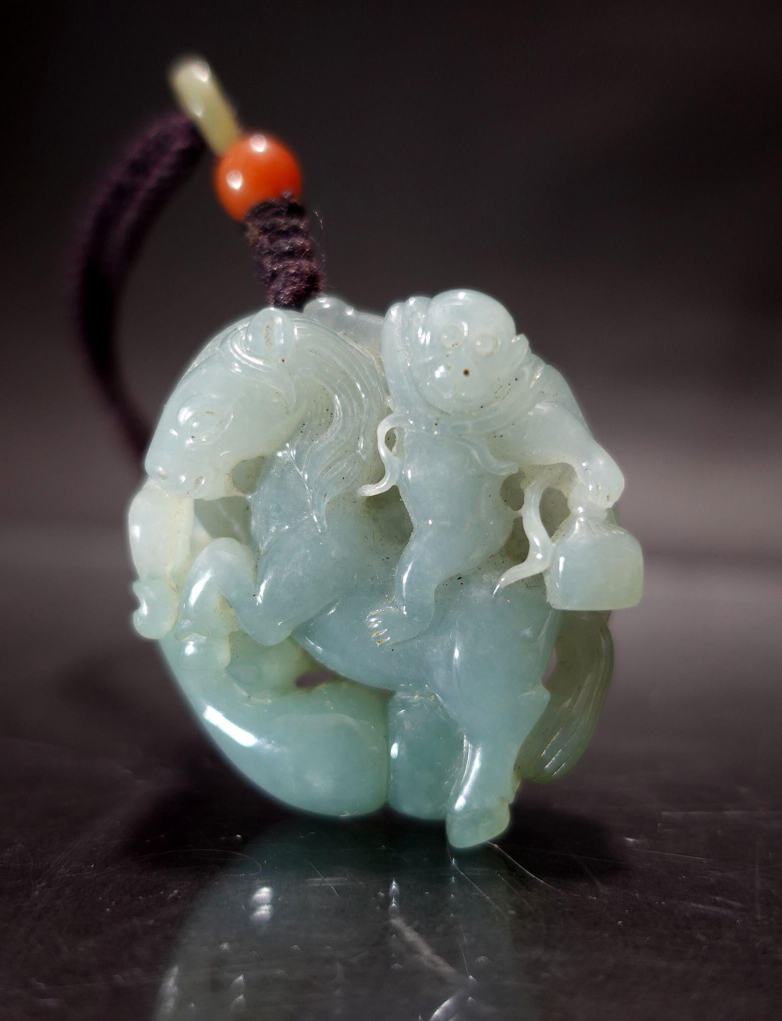 This is hand-carved loverly jadeite with a color of light blue. It's an oval shape and almost round. You may think it's a pendant, but in reality is a 360° carving with a Monkey riding a horse. Its meaning in the Chinese ancient culture depicts