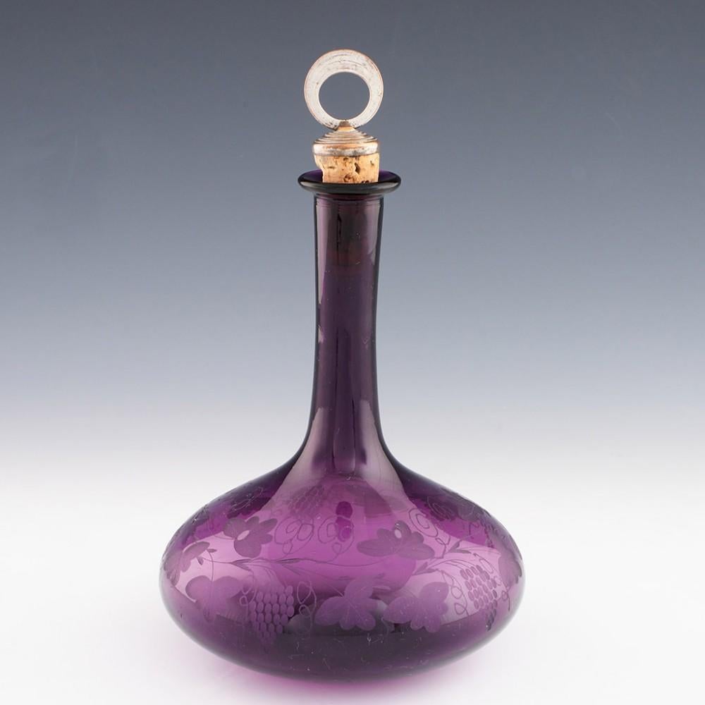 Heading : Finely Engraved Amethyst Glass Mell Decanter
Date : 1840-1860
Period : Victoria
Origin : England
Colour : Amethyst
Stopper : Cork stopper with Port label
Body : Mell
Base : Ovoid polished.
Glass Type : Lead.
Size :  25.8cm  cm to top of