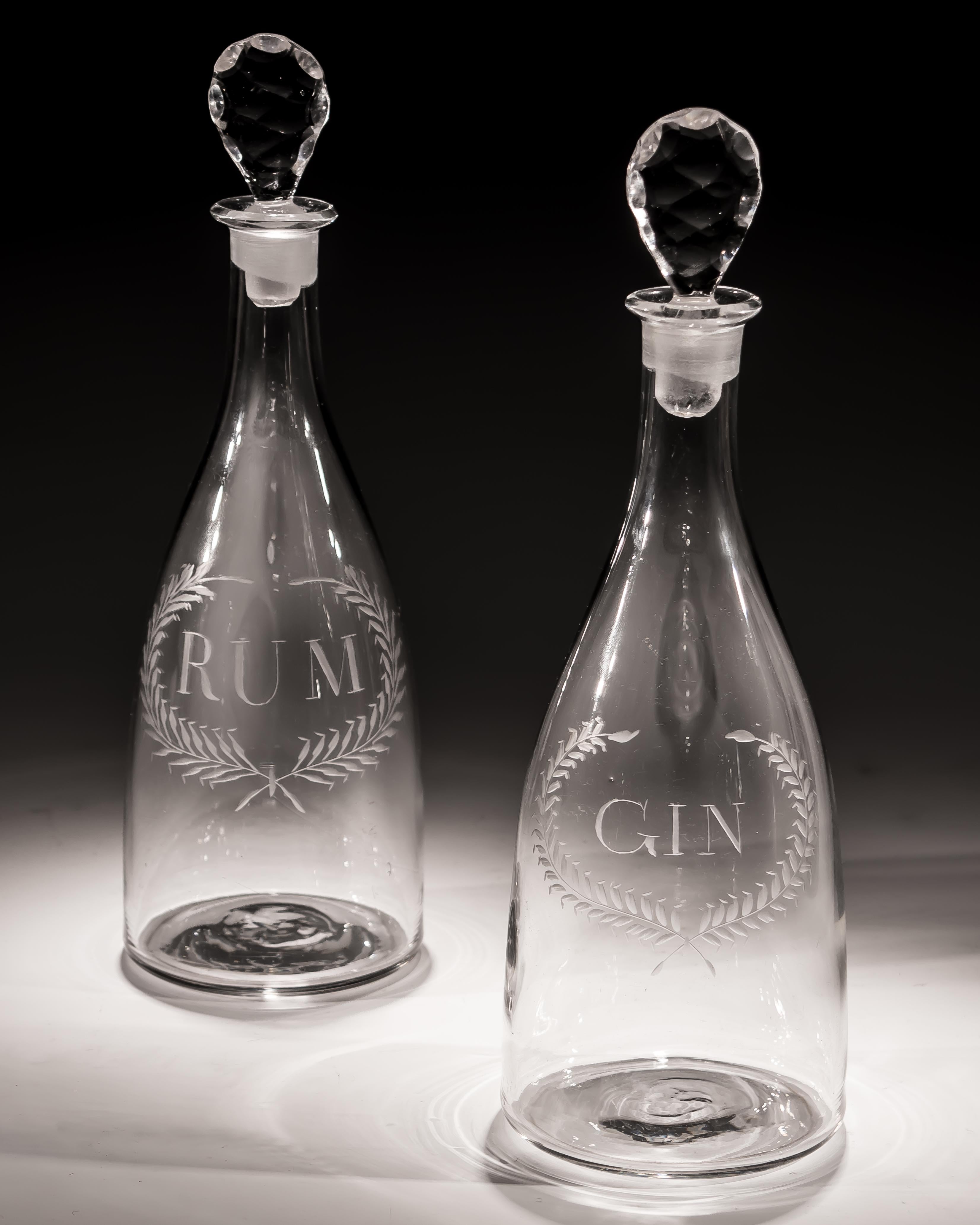 A finely engraved pair of Labelled Rum & Gin tapered Georgian decanters.