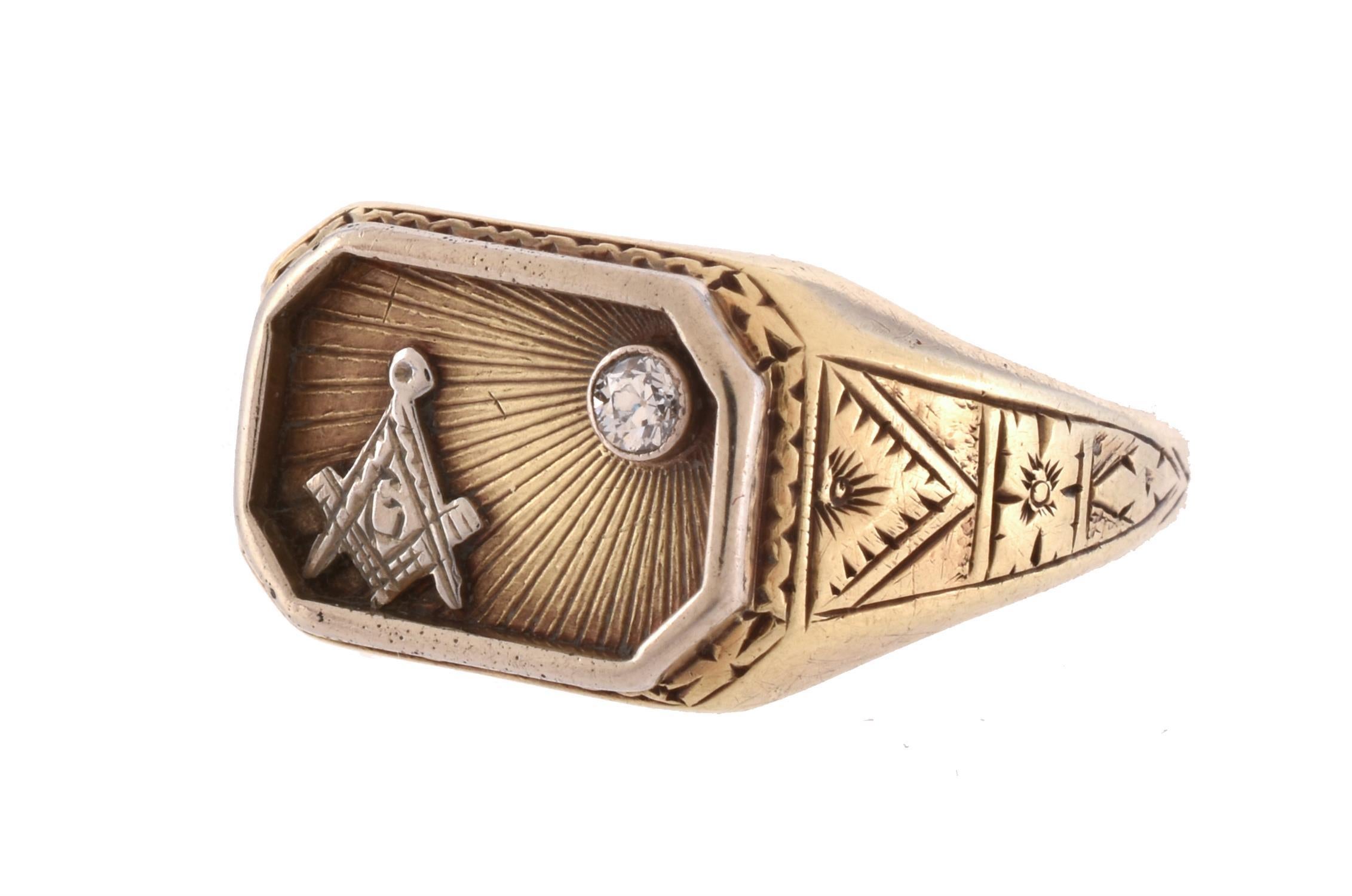 The octagonal panel set with an old brilliant cut diamond upon a radiating ground, with applied masonic monogram, to foliate engraved shoulders, stamped 14k, finger size 9 1/2
Weight: 5.9gr
