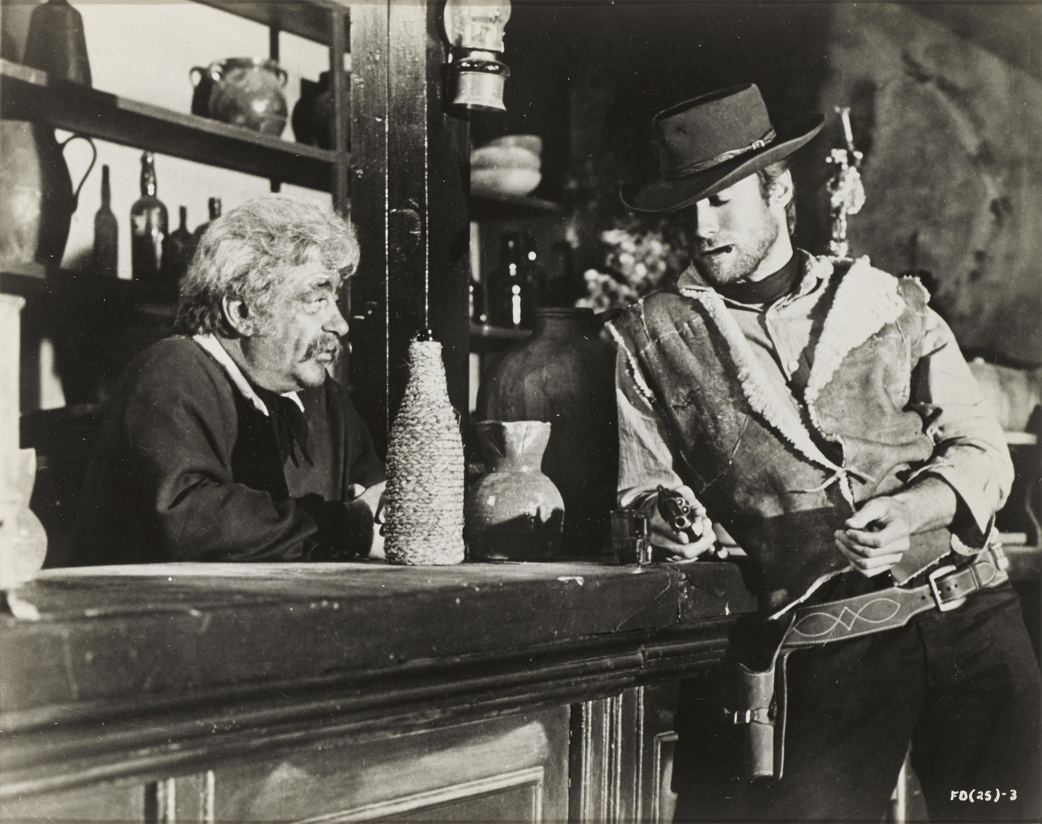 Original US photographic production still from the film A Fistful of Dollars 1964.
This film was directed by Sergio Leone, and starred Clint Eastwood in the first of his Dollars trilogy. This piece is framed in a Sapele wood
frame with acid free