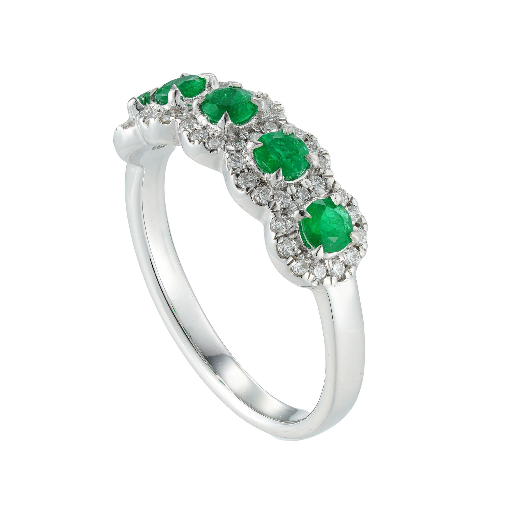 A five emerald and diamond cluster ring, the round faceted emeralds weighing 0.5 carats surrounded by small brilliant-cut diamonds weighing 0.25 carats in total, all claw-set in white gold mount, hallmarked 18ct gold Sheffield, the head measuring