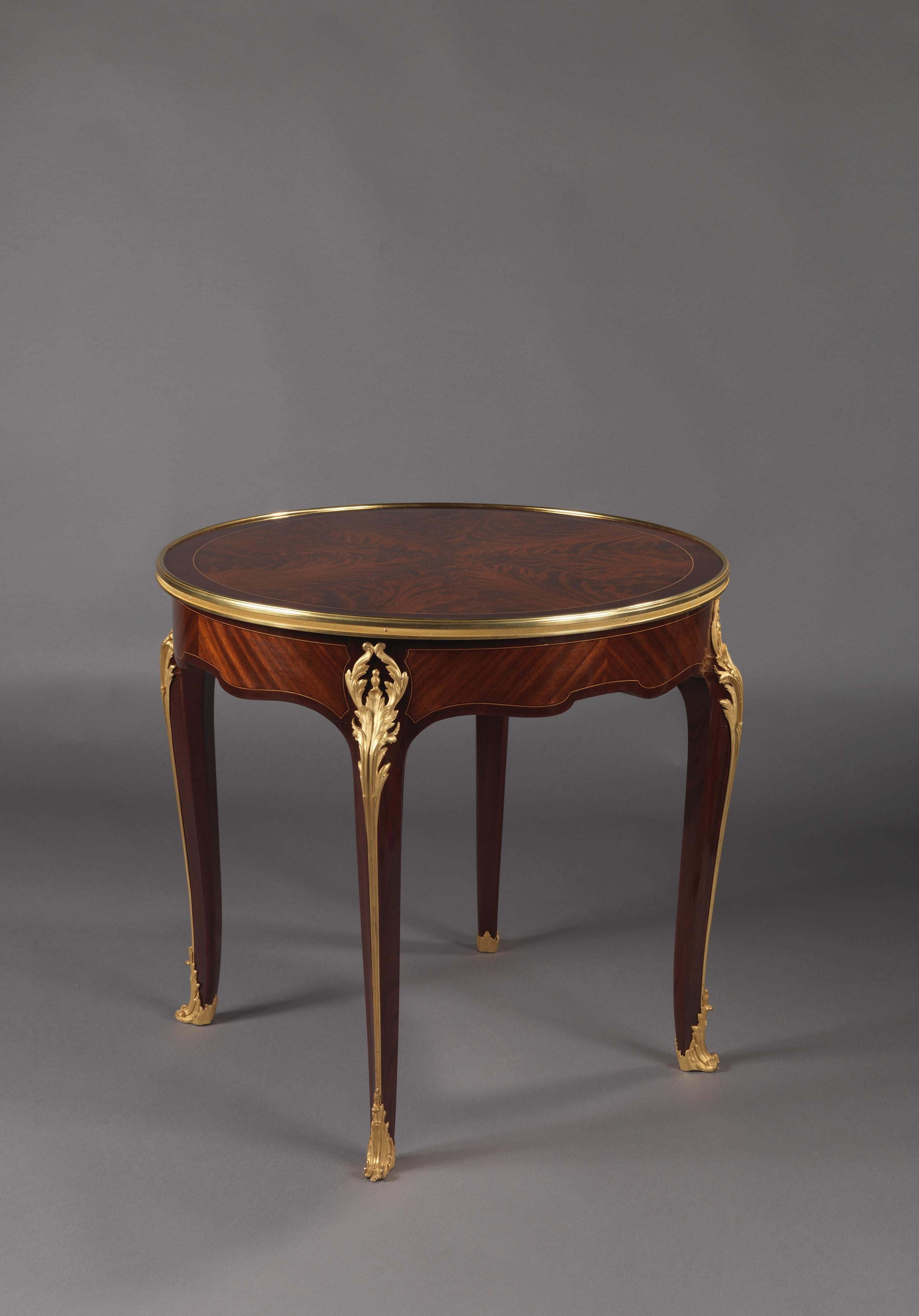 A fine gilt-bronze mounted flame mahogany and Satine Gueridon with a reversible baise lined top.

French, circa 1890. 

This fine gueridon has a circular top veneered in flame mahogany, the reverse with a green baise playing surface. The table