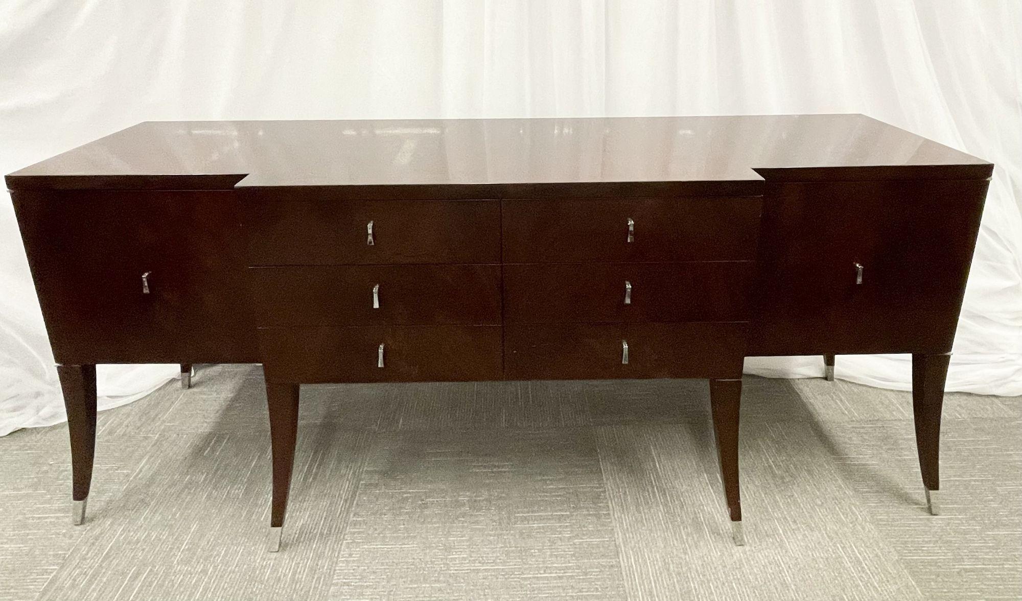 A flame Mahogany sideboard by Decca for Bolier
 
A Fine custom quality flame mahogany sideboard having 3 x 3 center drawers flanked by open square doors which contain two shelves each. On each side of the cabinet a 14