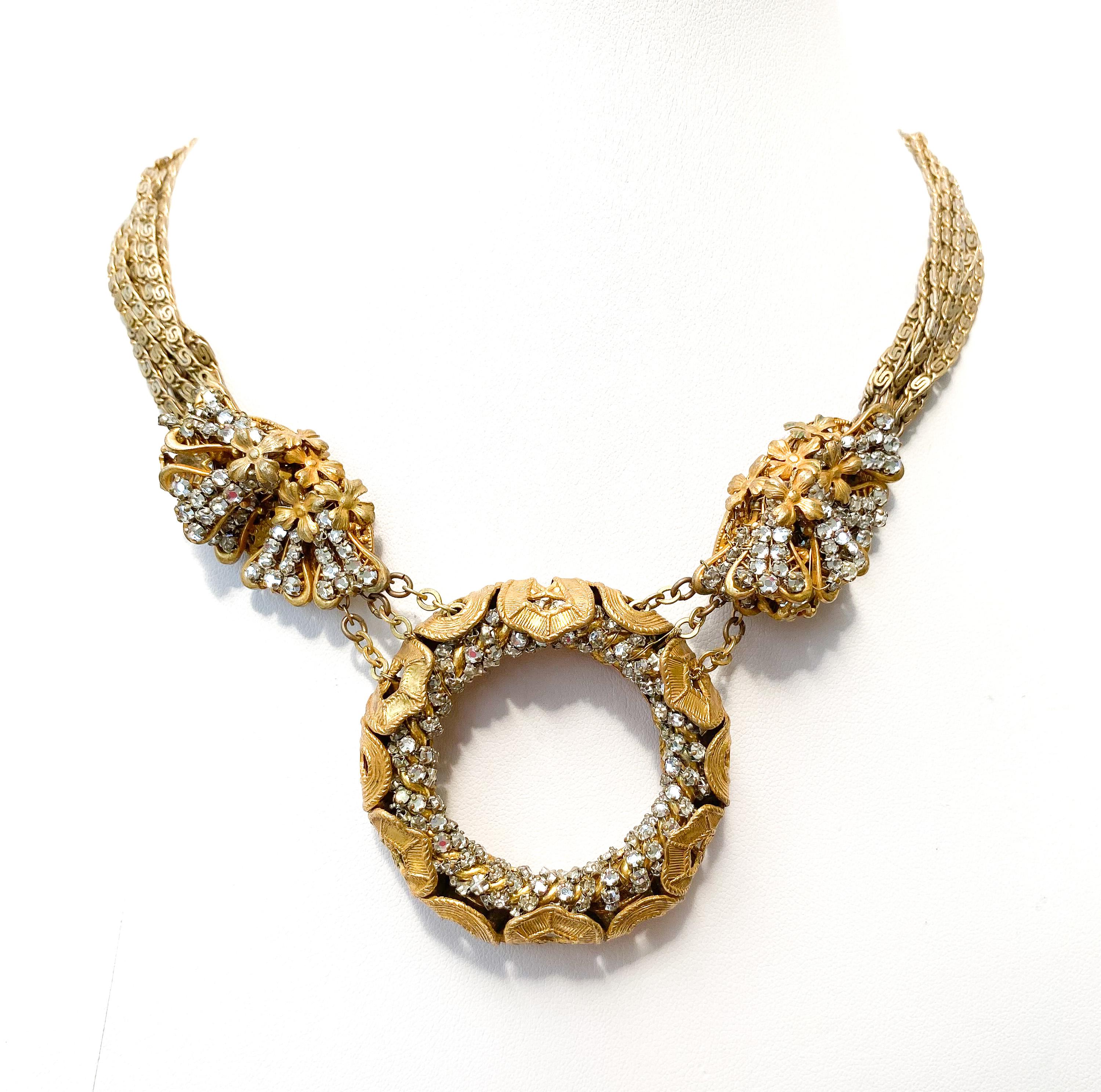 A splendid necklace deigned by the earliest and leading designer for Miriam Haskell, Frank Hess. Made from gilt metal and rose montes (clear flatback pastes individually set), it is classic vintage Haskell. Using an elegant flattened chain, hand