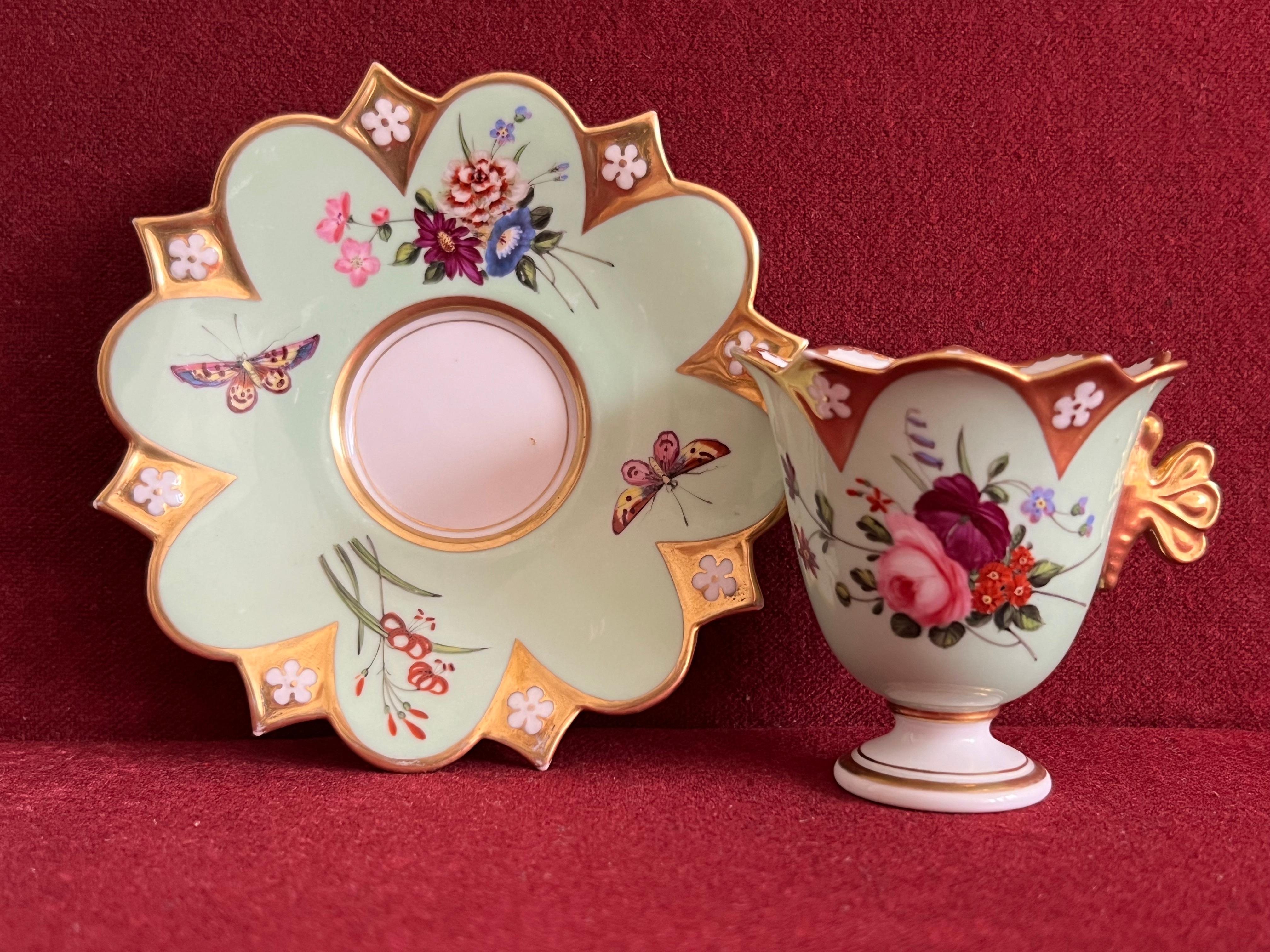 A Flight, Barr and Barr Worcester cabinet cup and stand c.1830. The small tulip shape cup applied with a gilt butterfly handle, the gilt shaped rims moulded with florets left in the white, painted with mixed bouquets and floral sprays, the stand