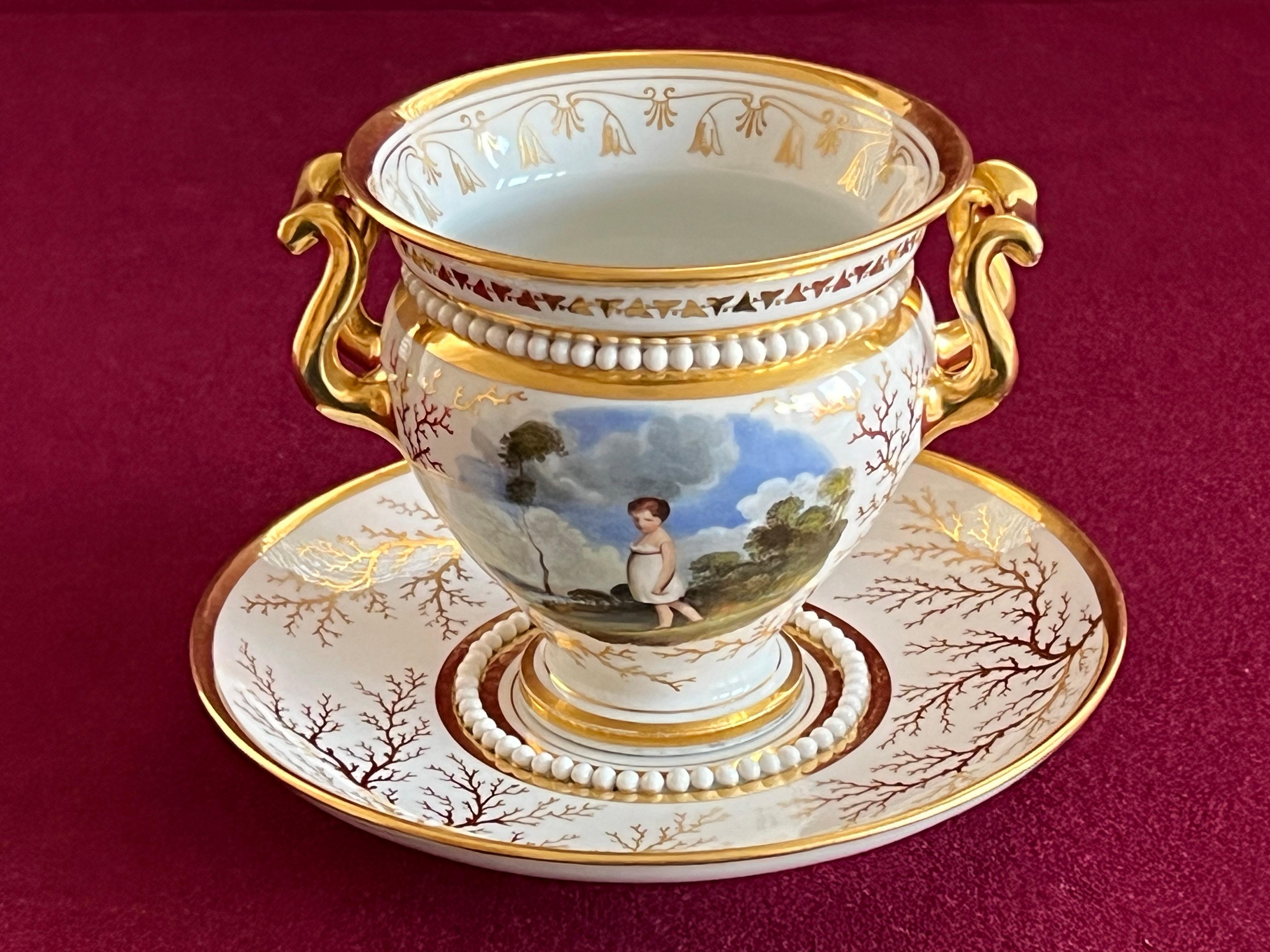 A superb and rare Flight, Barr and Barr Worcester porcelain cabinet cup and stand, c.1815. With twin gilded handles, broad everted rim and a band of white applied pearls below the rim. The front of the cup is finely painted with a scene of ‘The