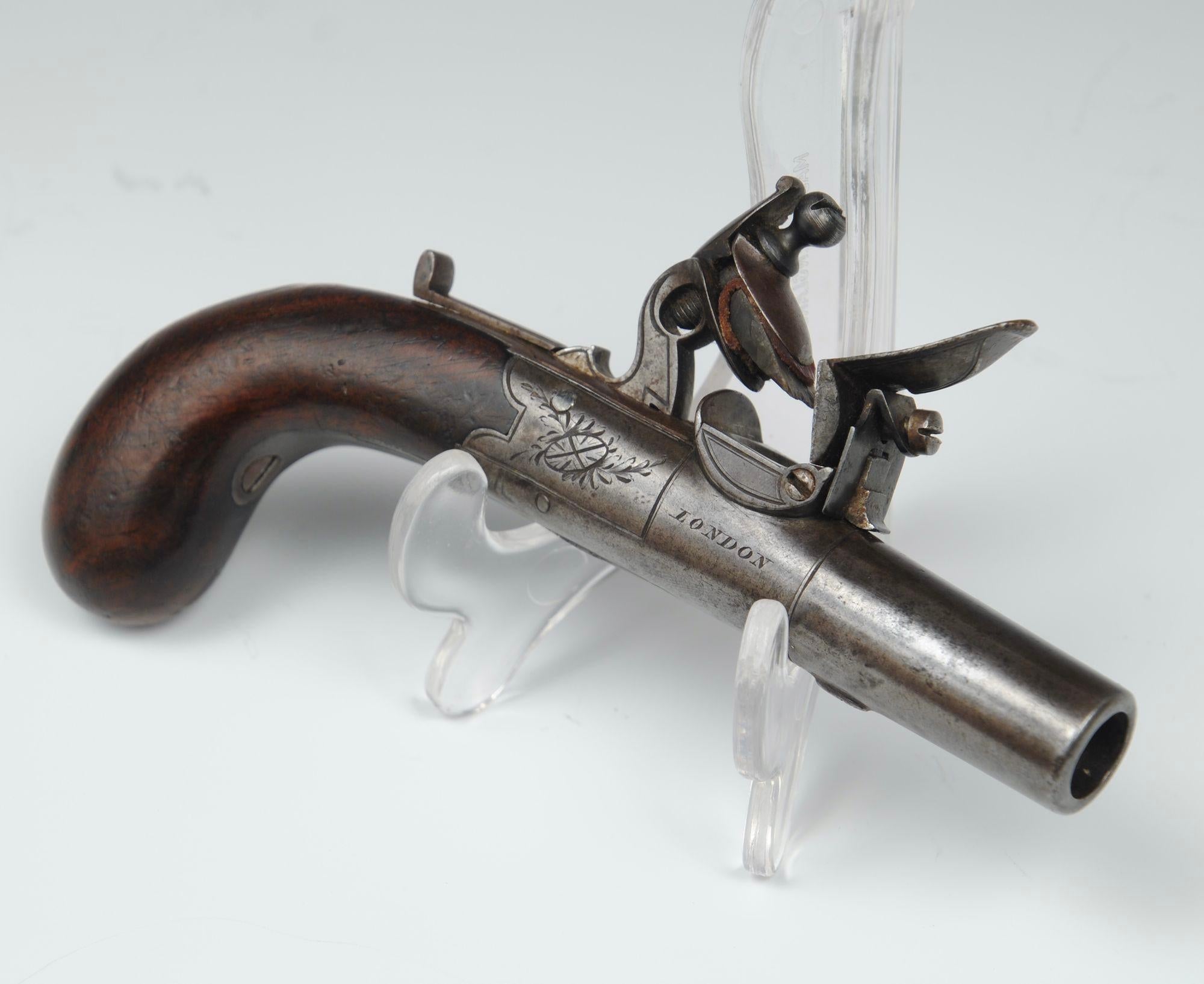 A late 18th century pocket pistol with hidden trigger and box lock by Lacy and Witton, London.
Barrel length 7cm, overall length 20cm