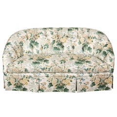 A Floral Loveseat with Tufted Back and Pleated Skirt