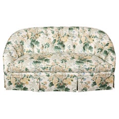 A Floral Loveseat with Tufted Back and Pleated Skirt