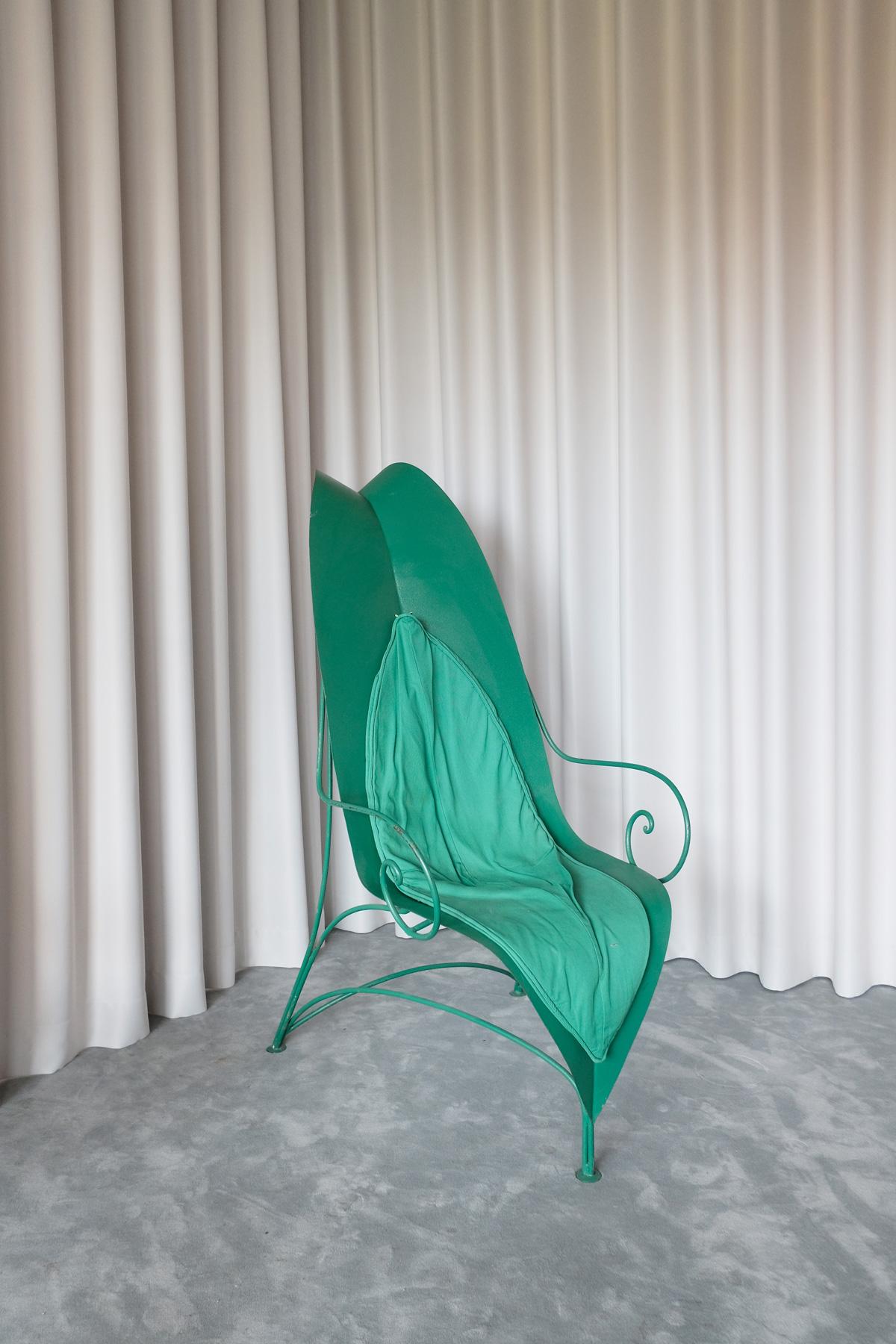 This armchair was designed by Fabrizio Corneli for Mirabili in 1989 and was entirely crafted by master artisans using iron. The striking seat and back are one piece that is shaped and colored to resemble a gigantic leaf in vivid green. The base