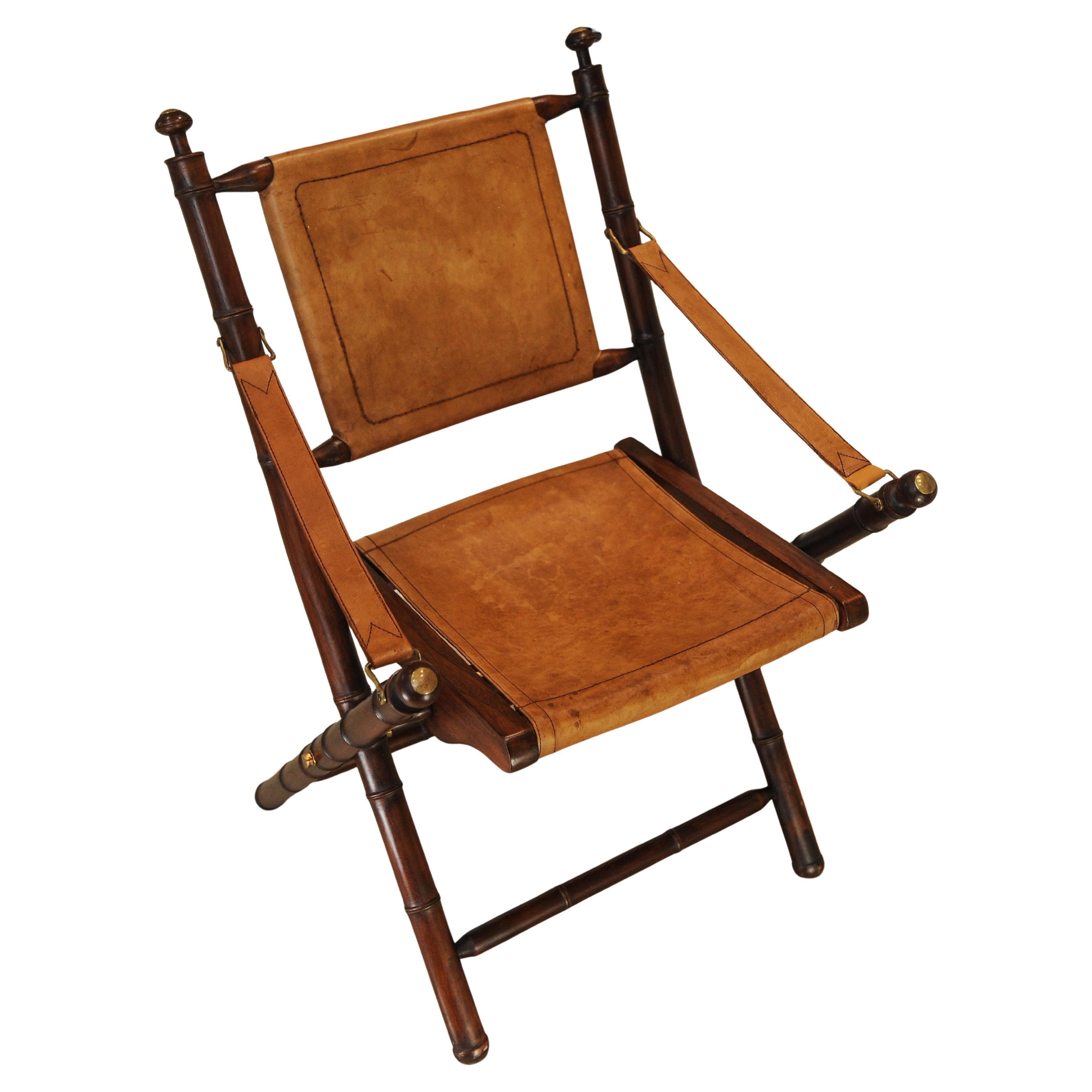 British A Folding Safari Chair With Stitched Tan Leather Straps & Seat Faux Bamboo Legs For Sale