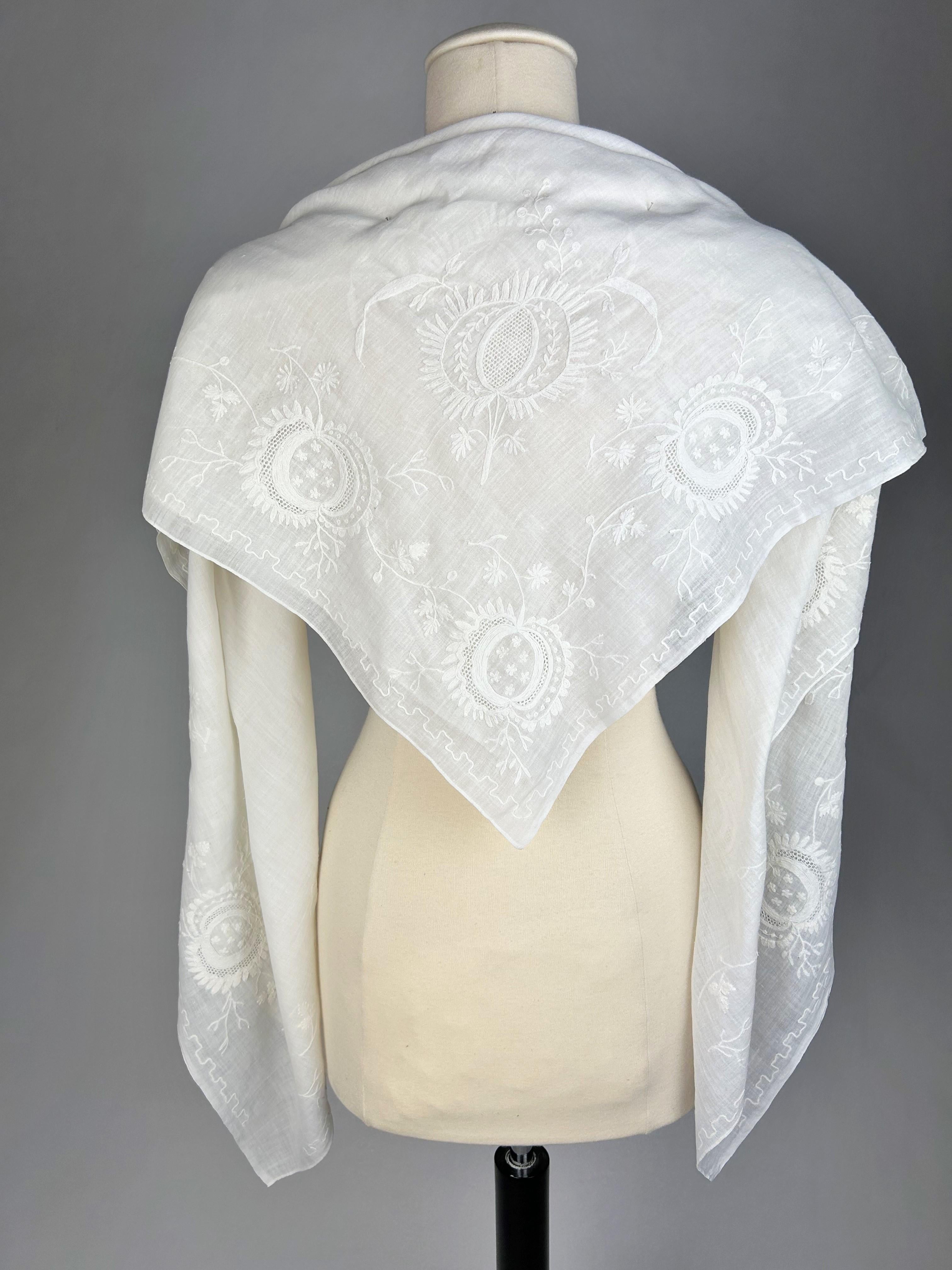 Circa 1780 /1820
France Provence

Large foldover cotton muslin fichu or shawl embroidered in Beauvais stitch and openwork with drawn threads. Elegant embroidery of foliage scrolls charged with large stylised pomegranates, and with a semis in the
