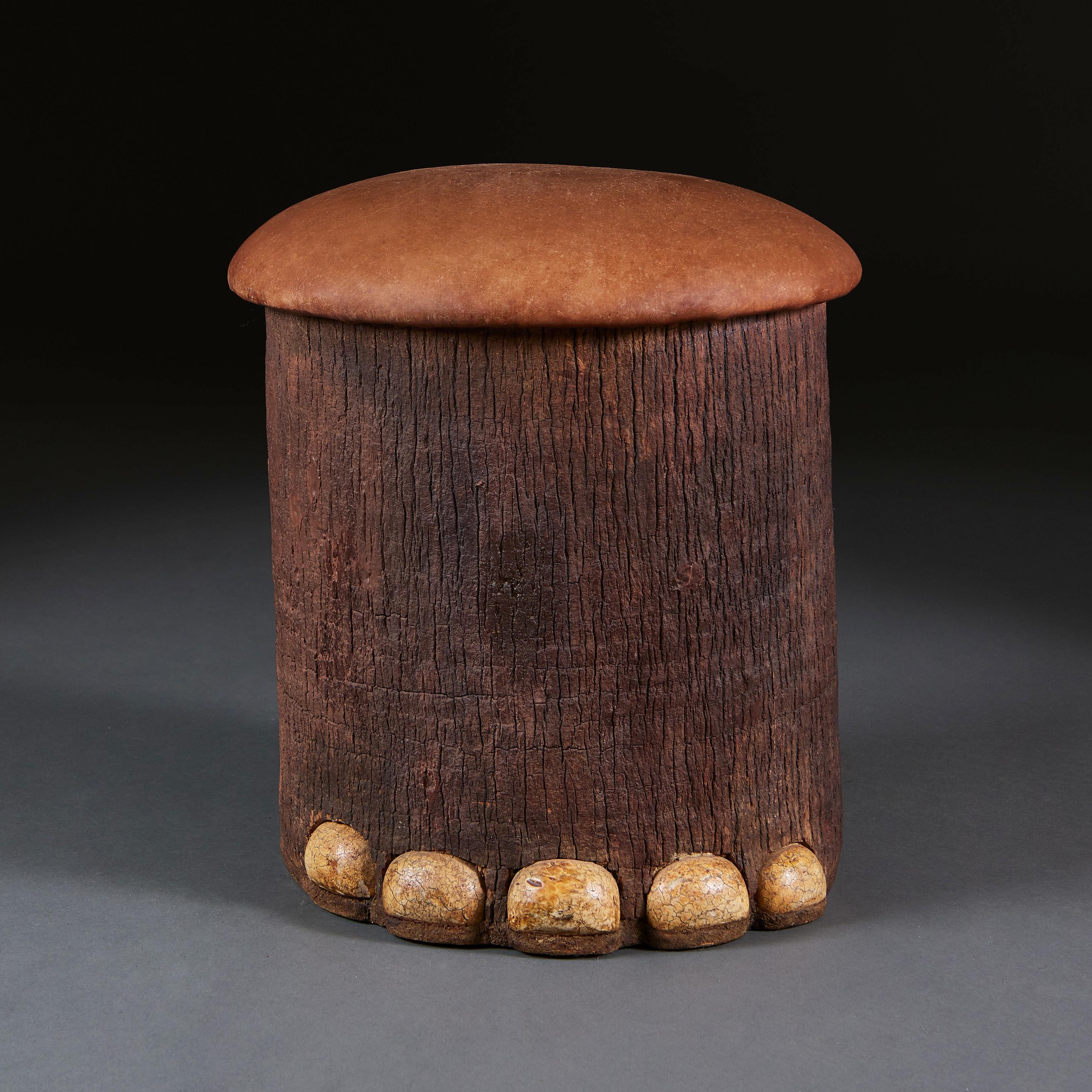 England, circa 1930

An unusual early twentieth century English faux elephant foot painted stool, comprised of carved tree bark base, crackle glazed toes and a tan leather seat.

Height 45.00cm

Diameter 43.00cm.