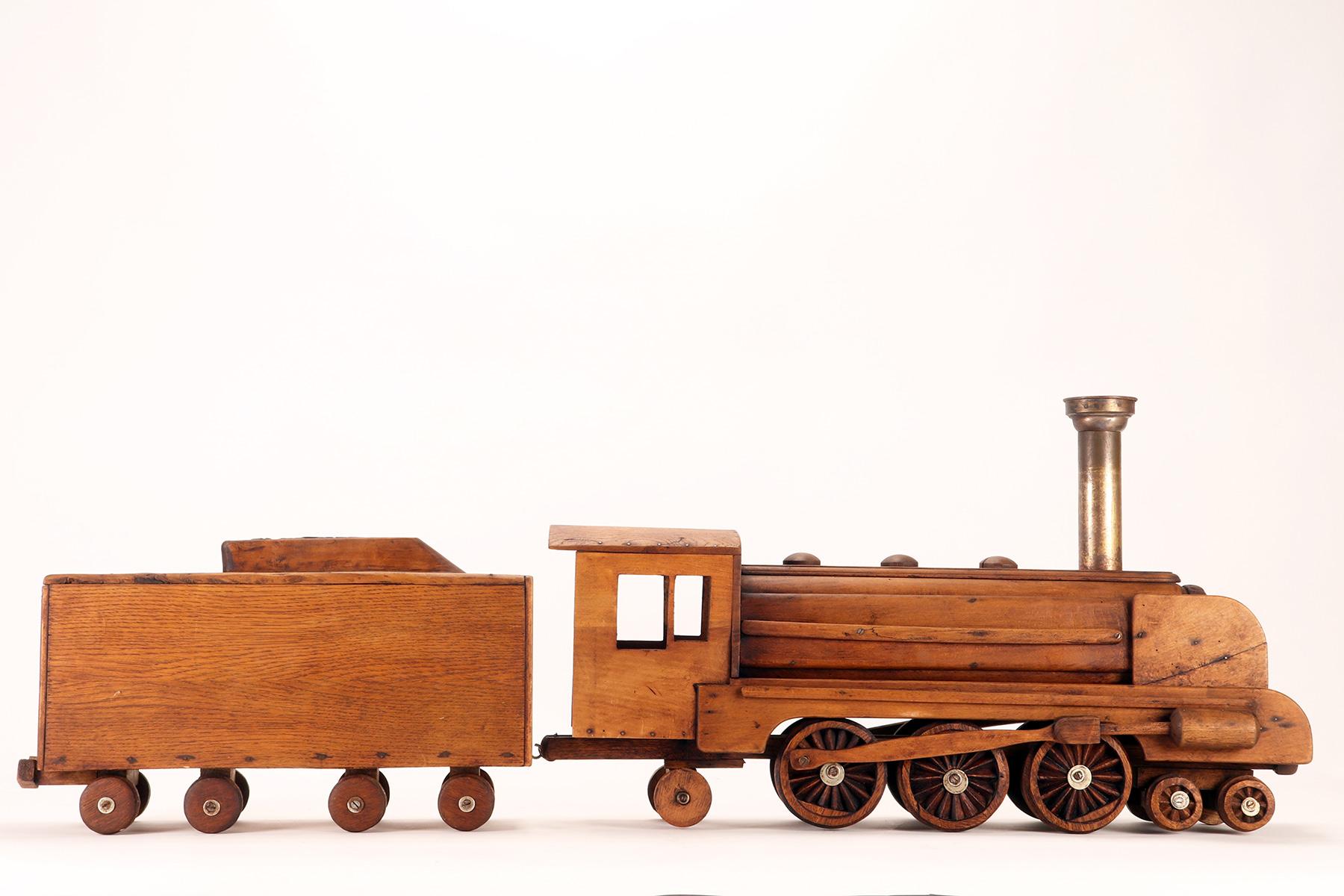Ein Volkskunstmodell eines Spielzeugs, das eine Dampfzug darstellt, USA 1900. (20. Jahrhundert) im Angebot