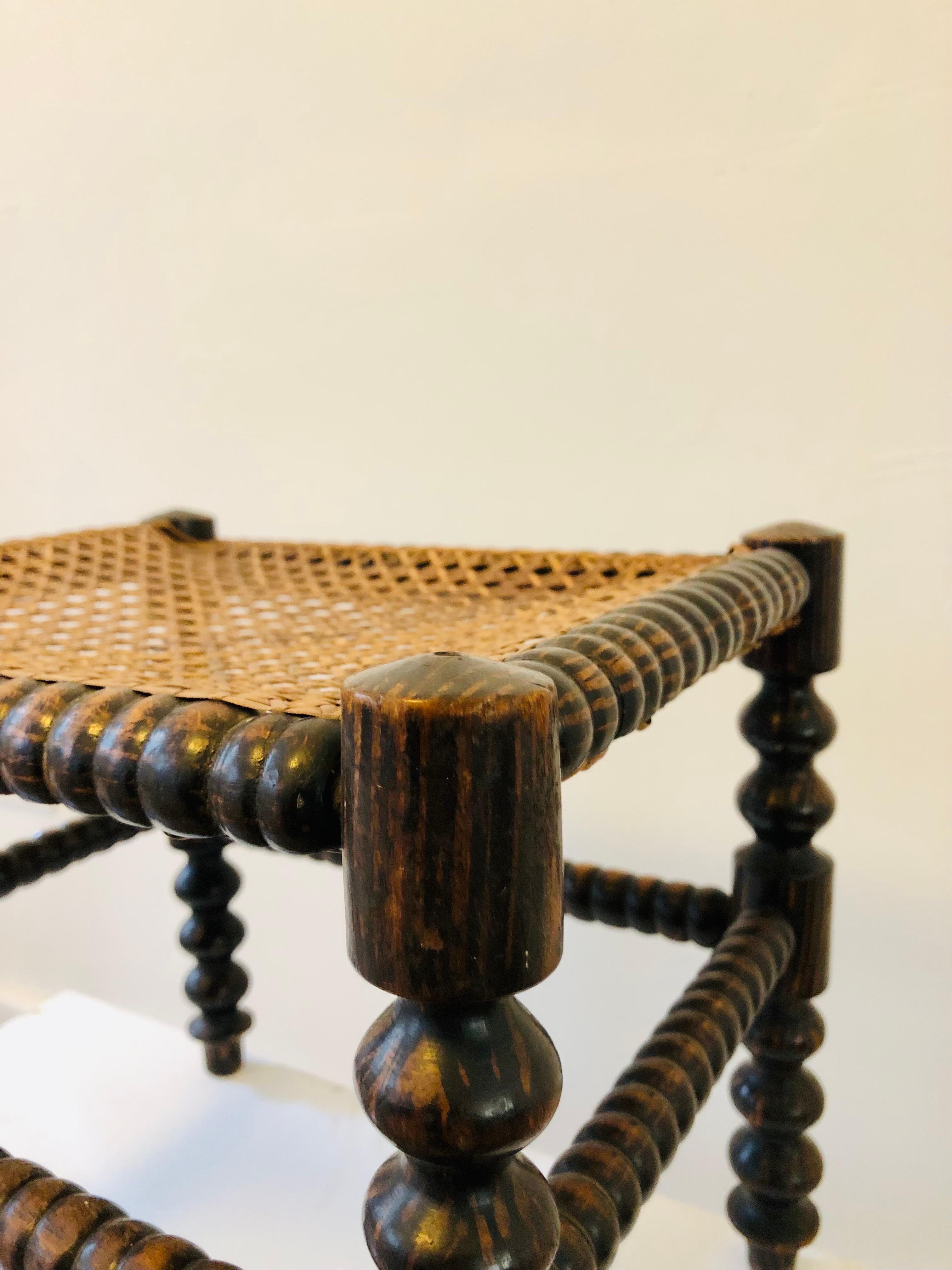 French A footstool from the early 20th century - turned wood and caning - France. For Sale