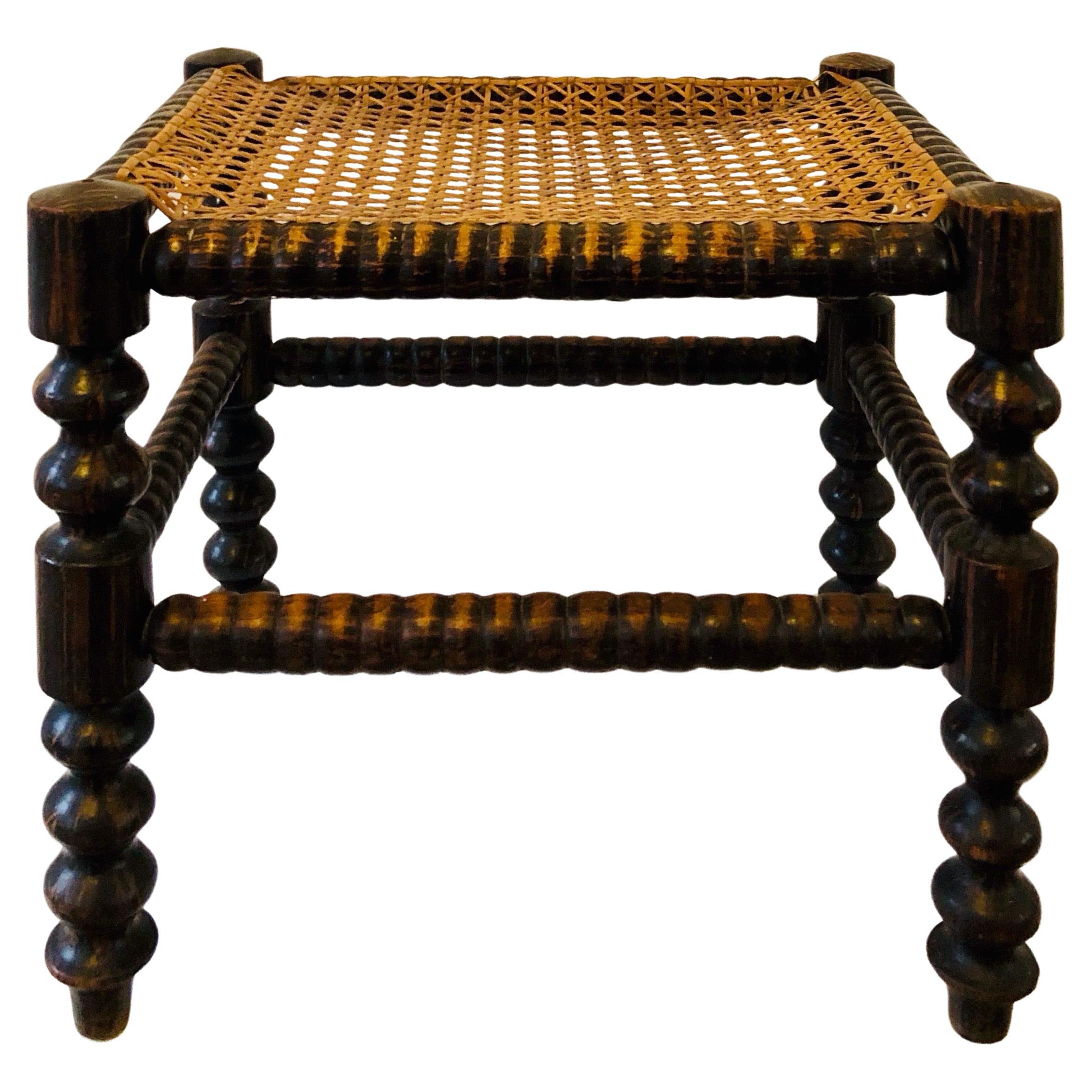 A footstool from the early 20th century - turned wood and caning - France. For Sale