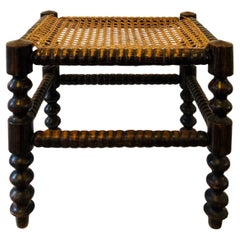 Antique A footstool from the early 20th century - turned wood and caning - France.