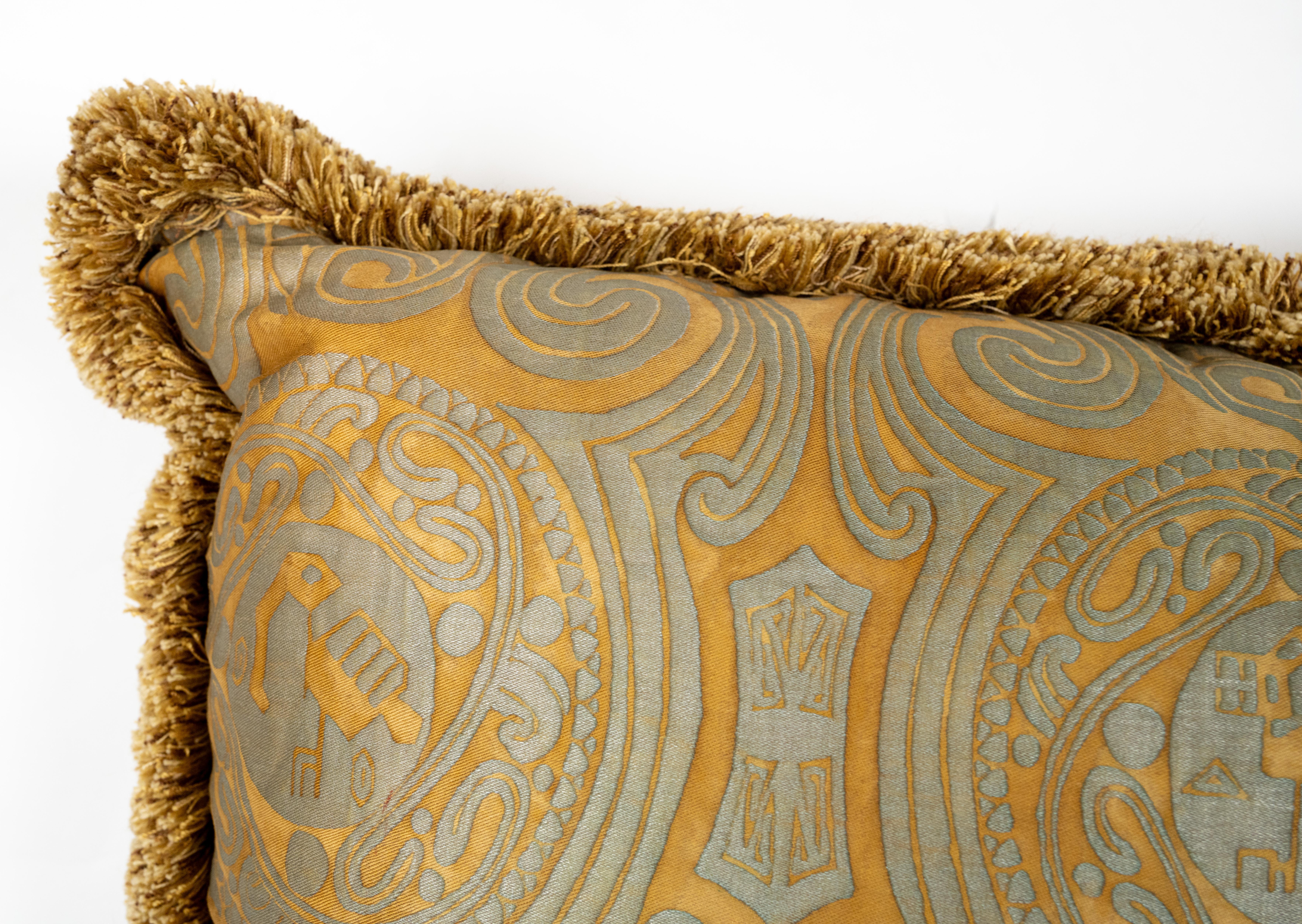 A Fortuny fabric cushion in the Peruviano pattern, in a rare, discontinued color. Features a unique brush fringe border.  The pattern, a Peruvian inspired design with scroll motif. Has a 50 down/50 feather insert. 