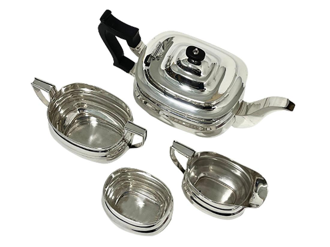 A four-piece English Sheffield rectangular Silver tea service

A four-piece Silver tea service, made by William Hutton & Sons, Sheffield
A teapot, a spoon vase, a sugar bowl and a milk jar
The tea pot with Ebony handles. All items are hall