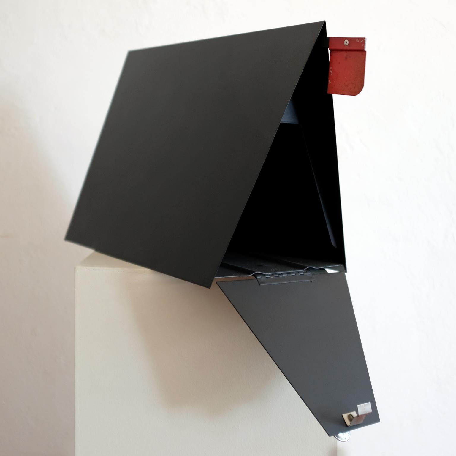 A-frame metal mailbox by Babco. Produced in the 1950s in Los Angeles California. It includes a retractable red flag to notify the postal carrier of outgoing mail.
