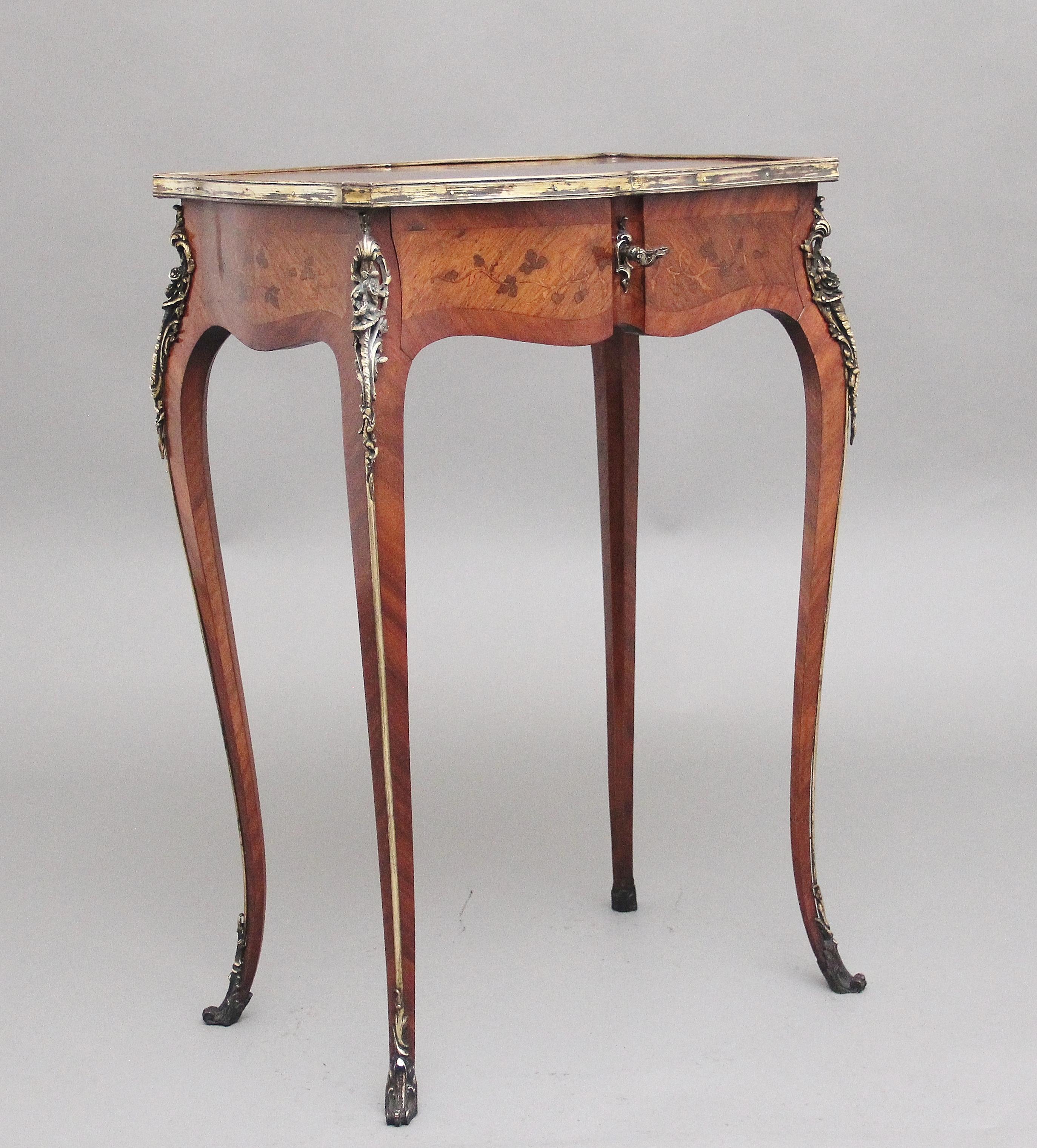 A freestanding 19th Century French Kingwood and marquetry side table, the shaped top decorated with floral marquetry and having a crossbanded edge, the edge of the top having brass moulding, the same decorative marquetry is also all sides of the
