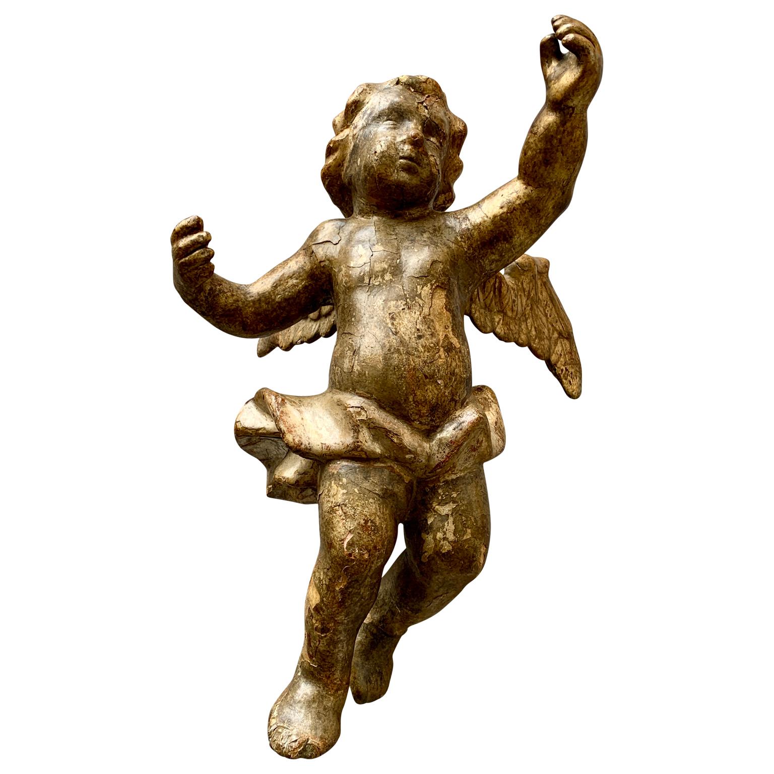A period European Louis XVI or Gustavian hand-carved and gilt hanging angel spreading its wings. The wooden hand-carved and silvered angel has small insignificant damages cause by the very high age, but keeps its very rare original patina. The