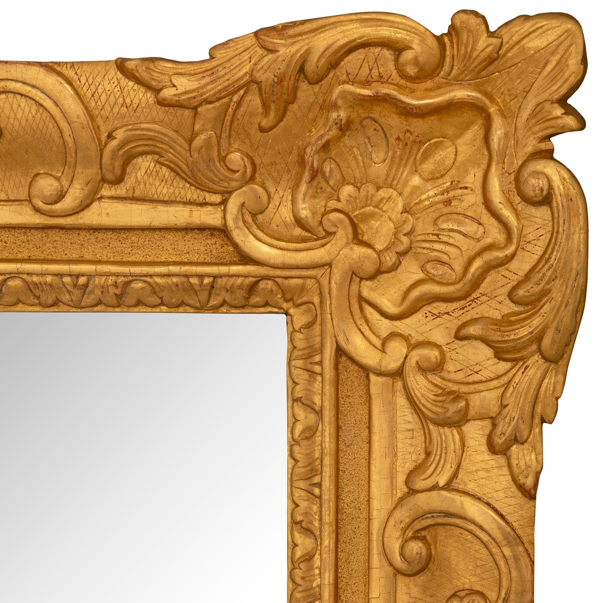 A French 18th century Regence period rectangular giltwood mirror In Good Condition For Sale In West Palm Beach, FL