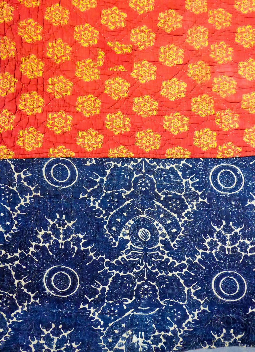 Circa 1800
France - Provence

Large quilt printed with indigo wax by using resist-dying (circa 1780) on one side, and an Indienne with red background and yellow starry wheels from the Napoleonic period (circa 1805) on the other side. Rustic