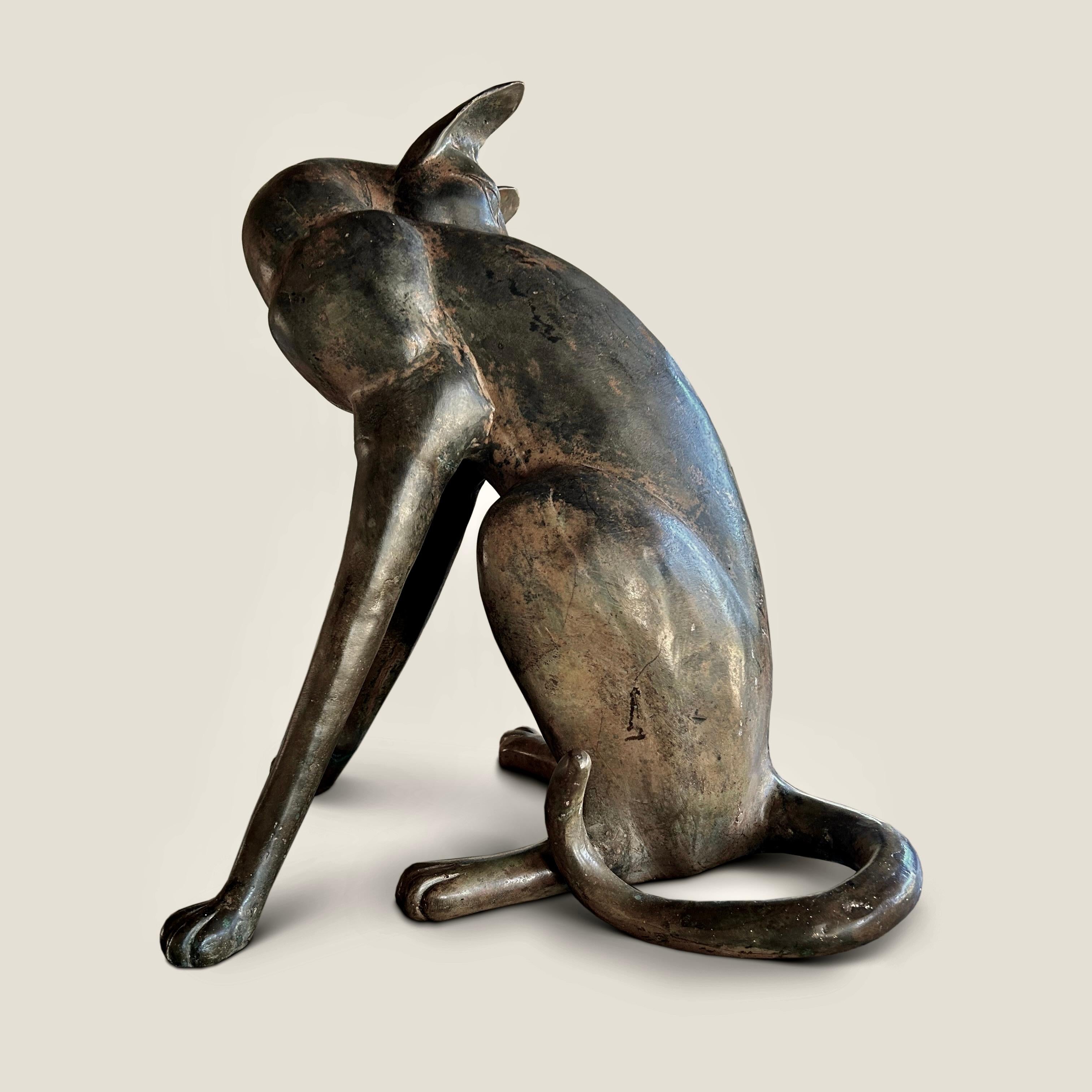 A fine French bronze figure of an Egyptian revival cat in a seated position, circa 1920, mottled brown patina.