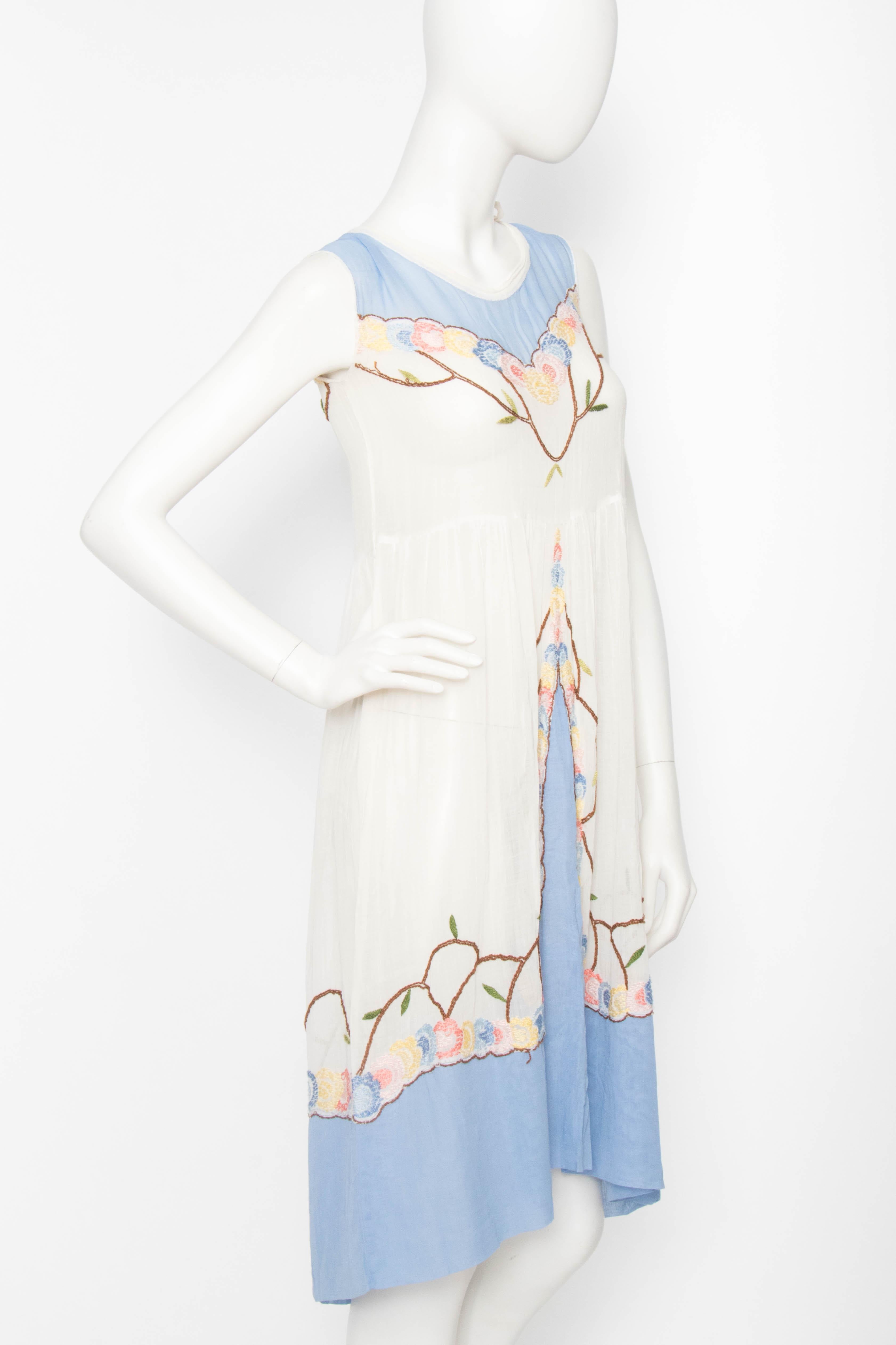 A great 1920s vintage french embroidered dress made in thin cotton with a round neckline, a fitted waist, and the most delicate floral embroidery. 

The size of the dress corresponds to a modern size small, but please see the measurements below to