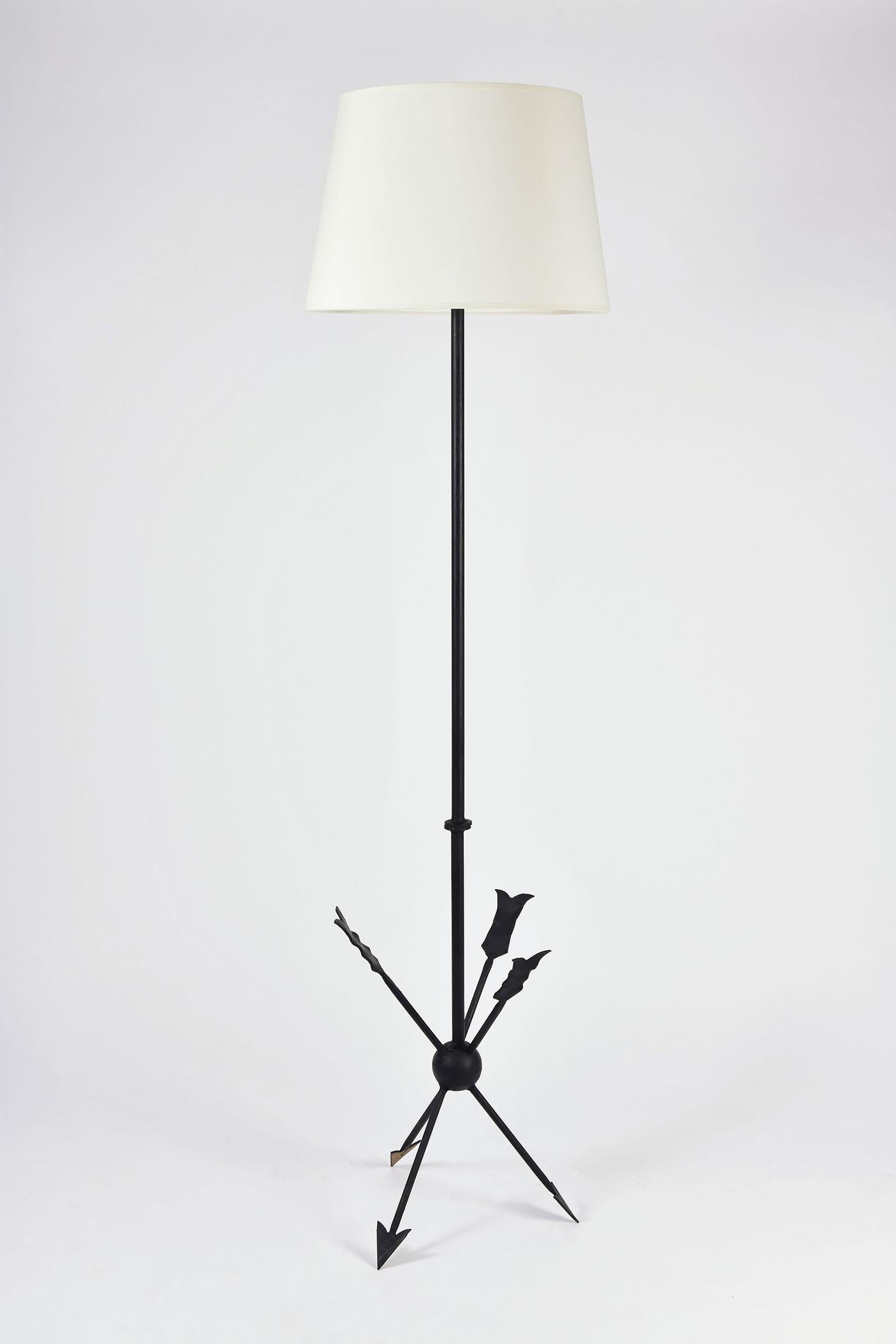 A black enameled wrought iron floor lamp, on an arrow tripod base
France, circa 1940
The stated dimensions include the shade.