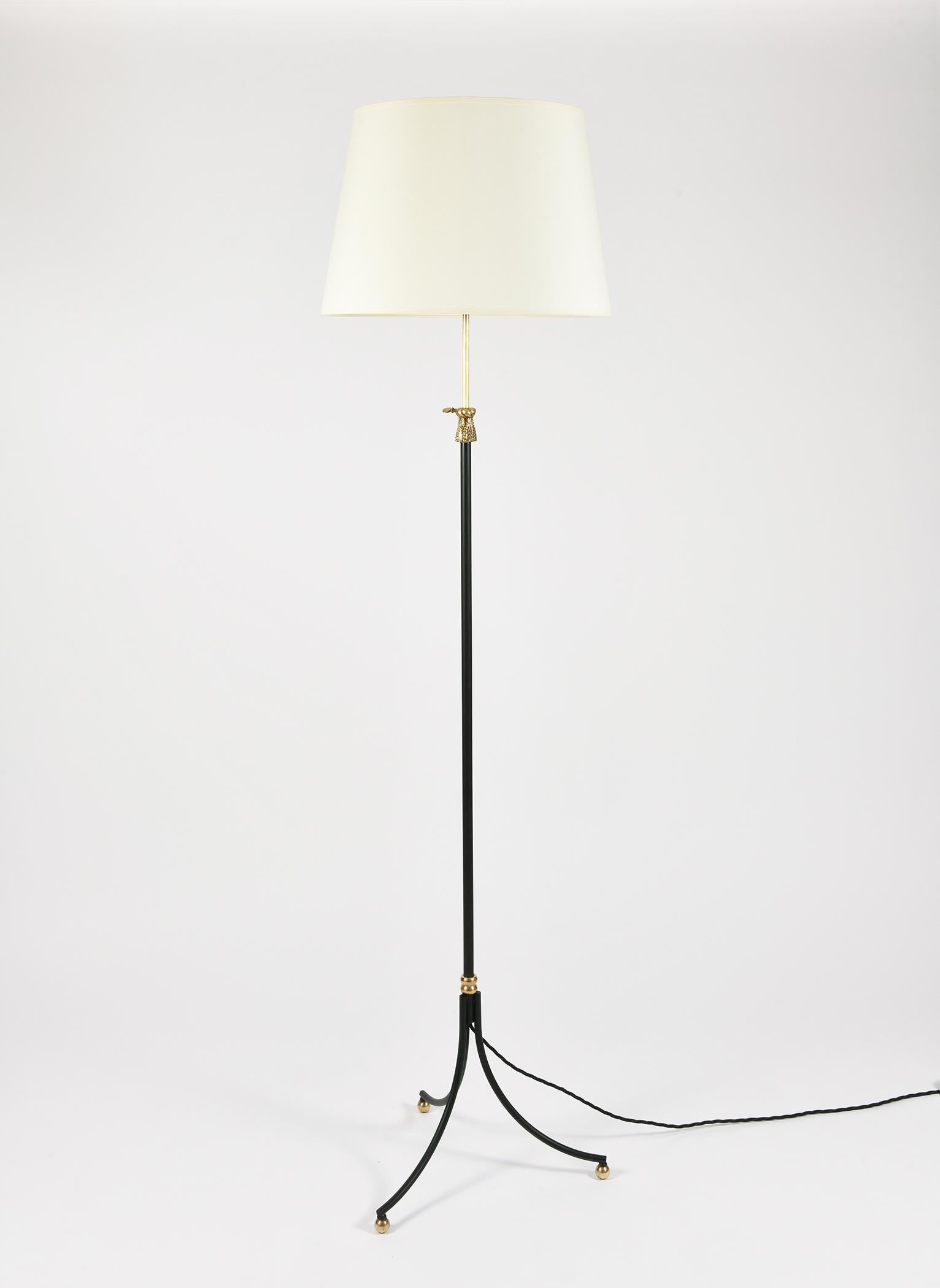 A brass and black enameled iron telescopic tripod floor lamp, with a tassel detail allowing the stem to be adjusted to the desired height.
With a bespoke lampshade.
France, circa 1950
The stated measurement include the shade and the height shown
