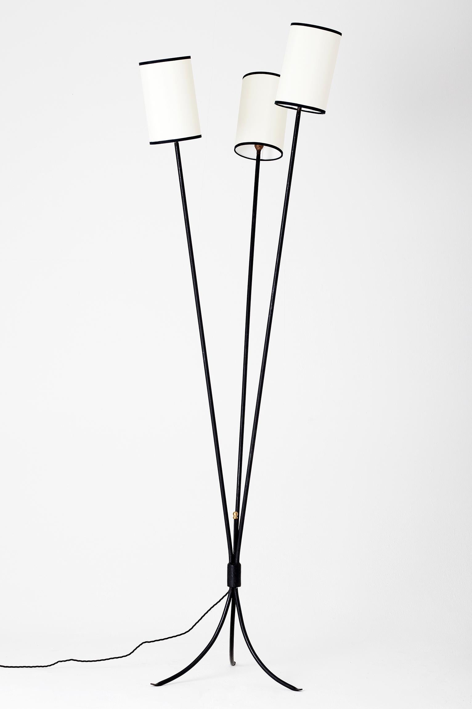 A black enameled iron triple stemmed floor lamp, with bespoke shades
France, circa 1950.