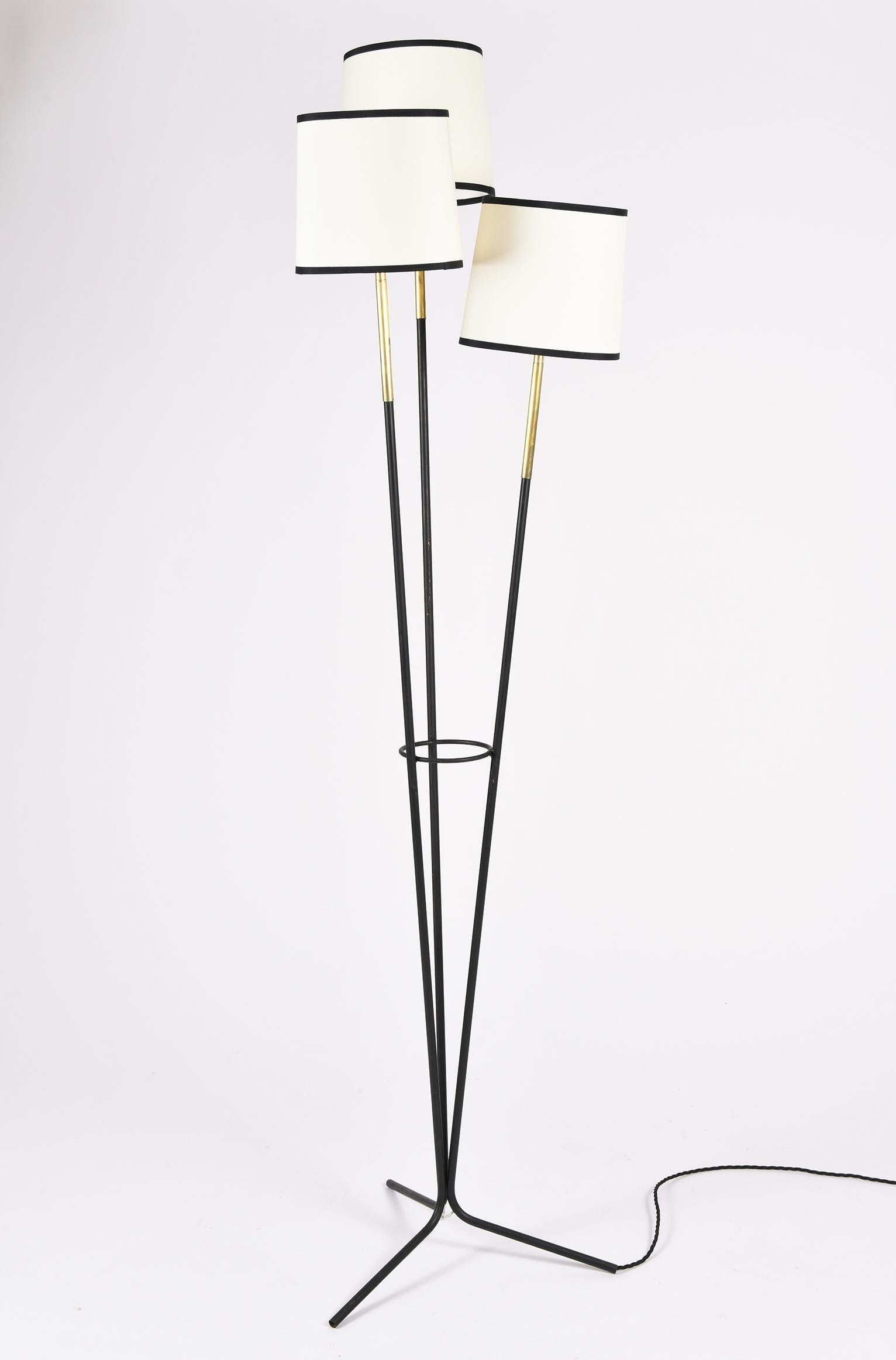 A triple stem black enamelled iron and brass tripod floor lamp
With bespoke lamp shades
France, circa 1950.