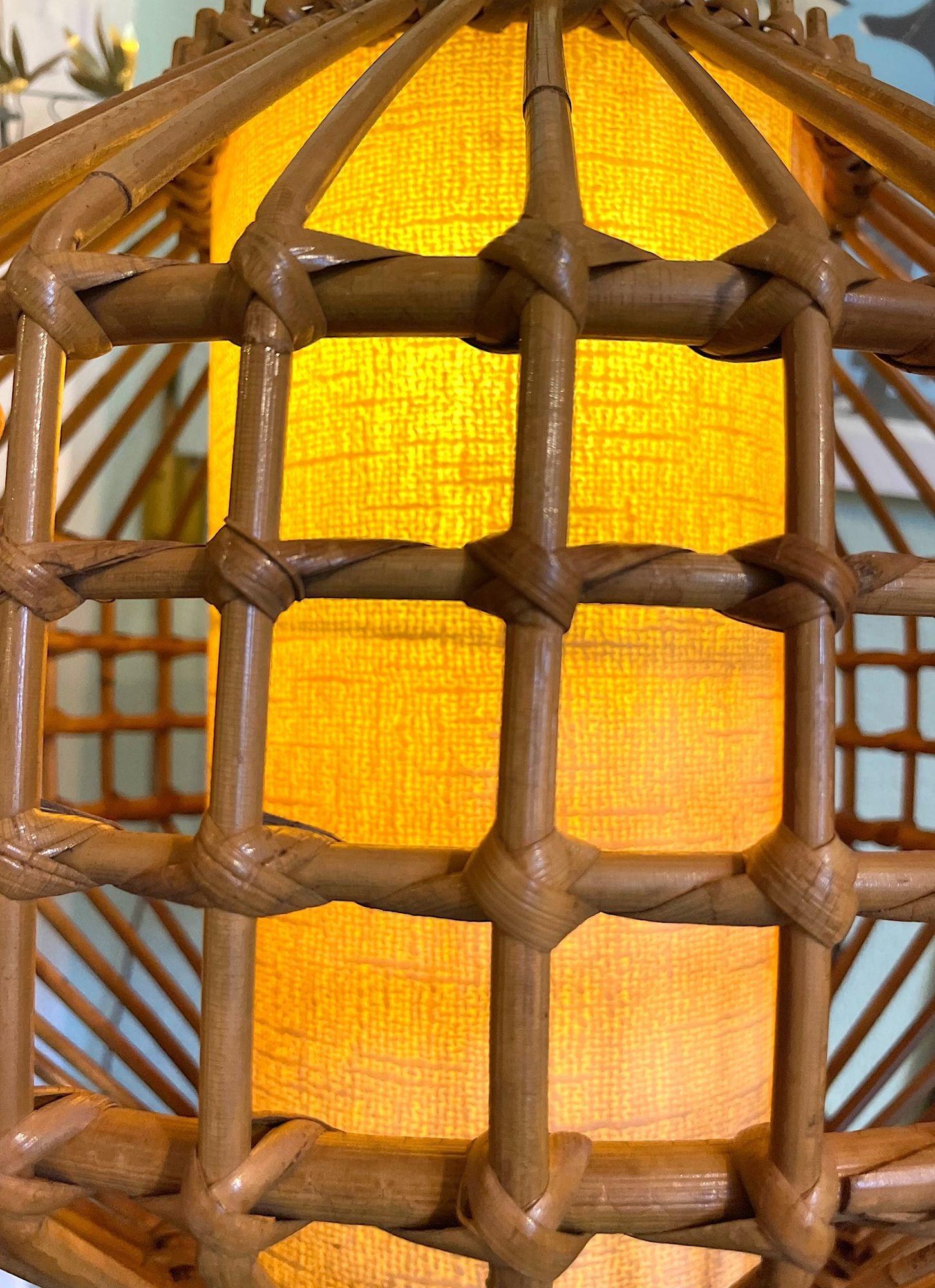 An unusual designed French 1970s woven bamboo hanging light by Louis Sognot with orignal parchment diffuser inside and orignal bamboo hanging chain.