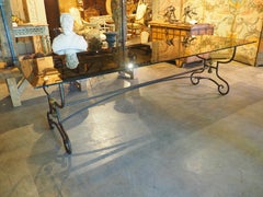A French 1970s Wrought Iron and Brass Dining Table with Smoked Glass Top