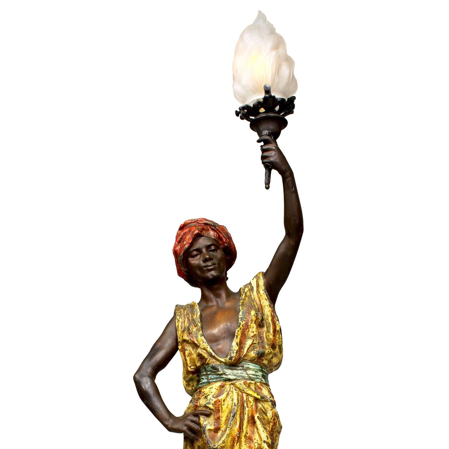 A French 19th-20th Century Orientalist Style Cold Painted Spelter Figural Lamp-Torchere, by Barcelona born artist Pedro Ramon Rigual (1863-1917). The charming lamp sculpture depicts a middle-eastern man wearing a turban and a vibrant color stripped