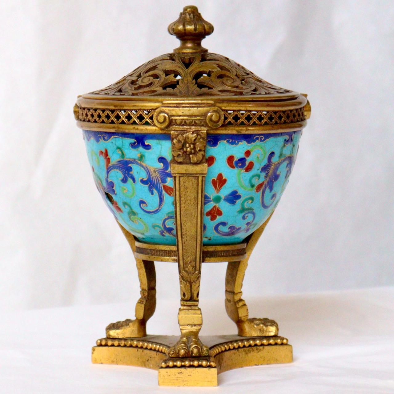 A French 19th century perfume or pot pourri vase 
A hand-painted polychromed enamel on copper Chinese Export bowl designed with flowers and rinceaux, ormolu-mounted as an Athénienne used as Pot Pourri. Rest-ing on three claw feet, the Arabesque